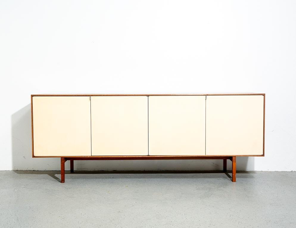 Vintage model 541 credenza by Florence Knoll for Knoll, 1960s. Walnut construction with off-white doors. Nice box-joint detail at the legs. Signed by the manufacturer underneath.