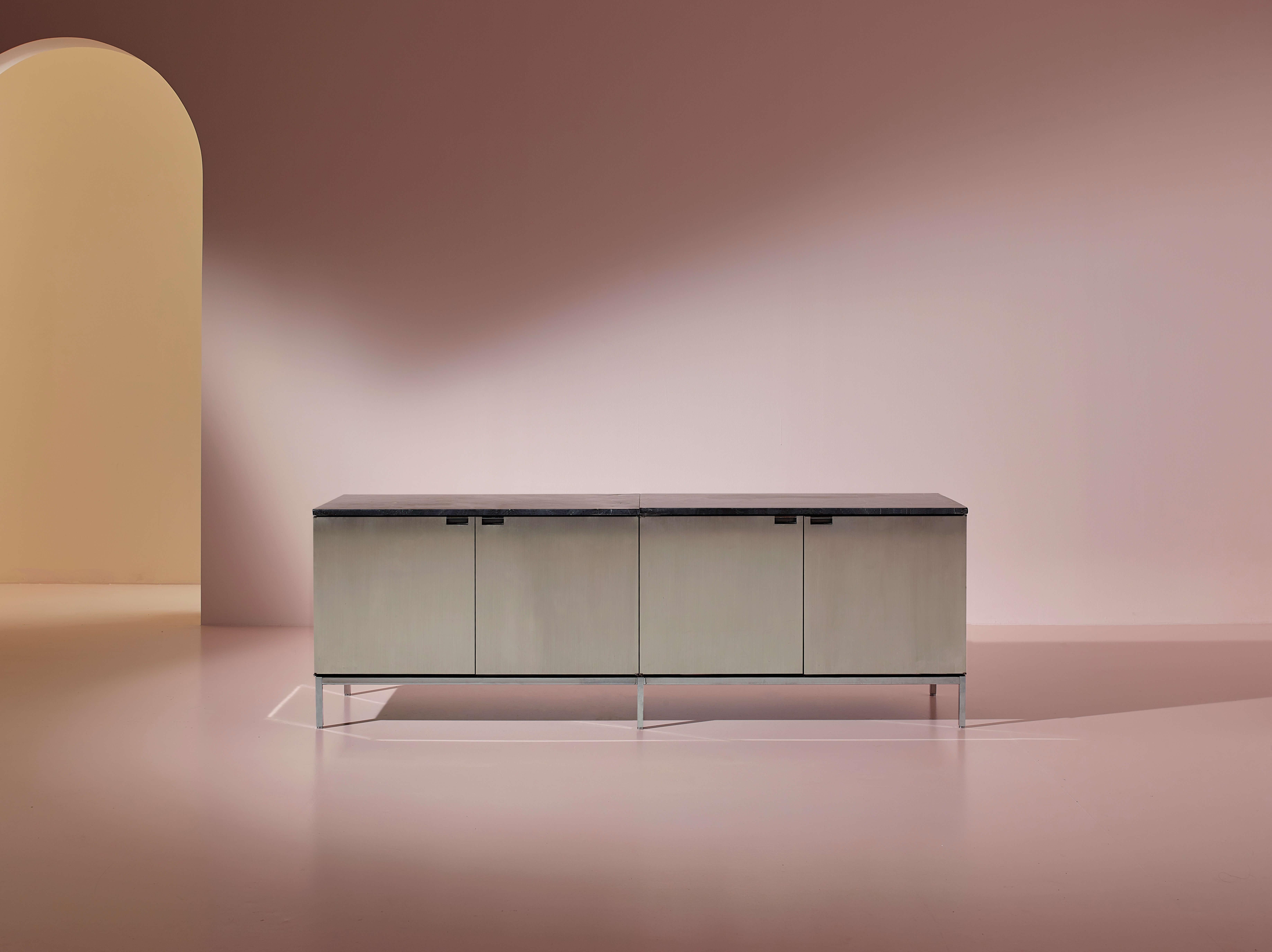 Four-door sideboard in wood, metal, and brushed aluminum, with a marble top, produced by Knoll, designed by Florence Knoll, 1960s

A long life, great masters, and well-deserved lasting success. The influence of Florence Knoll profoundly shaped