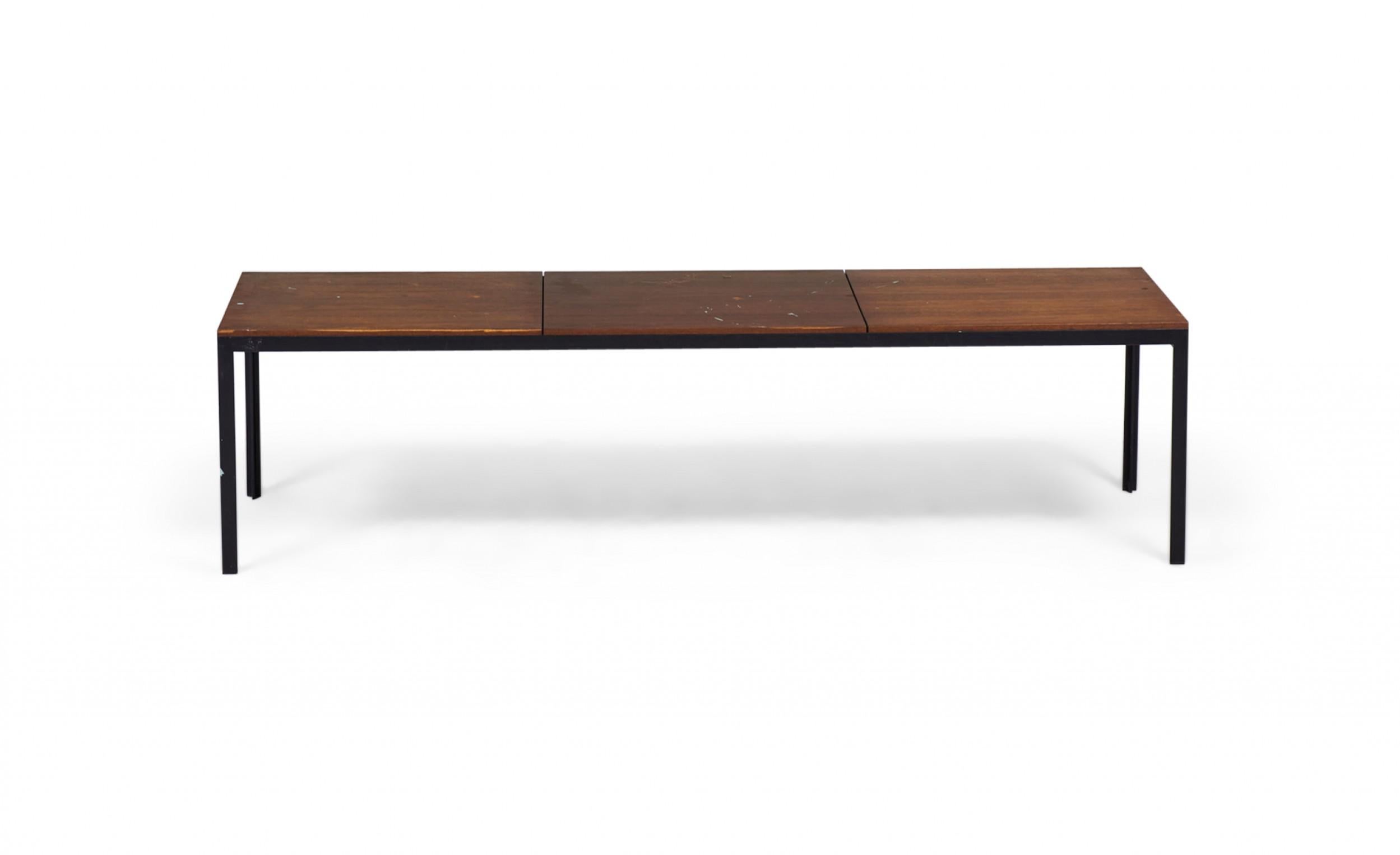 American Mid-Century rectangular coffee / cocktail table with a walnut top supported on a T-shaped black metal base. (FLORENCE KNOLL).
 