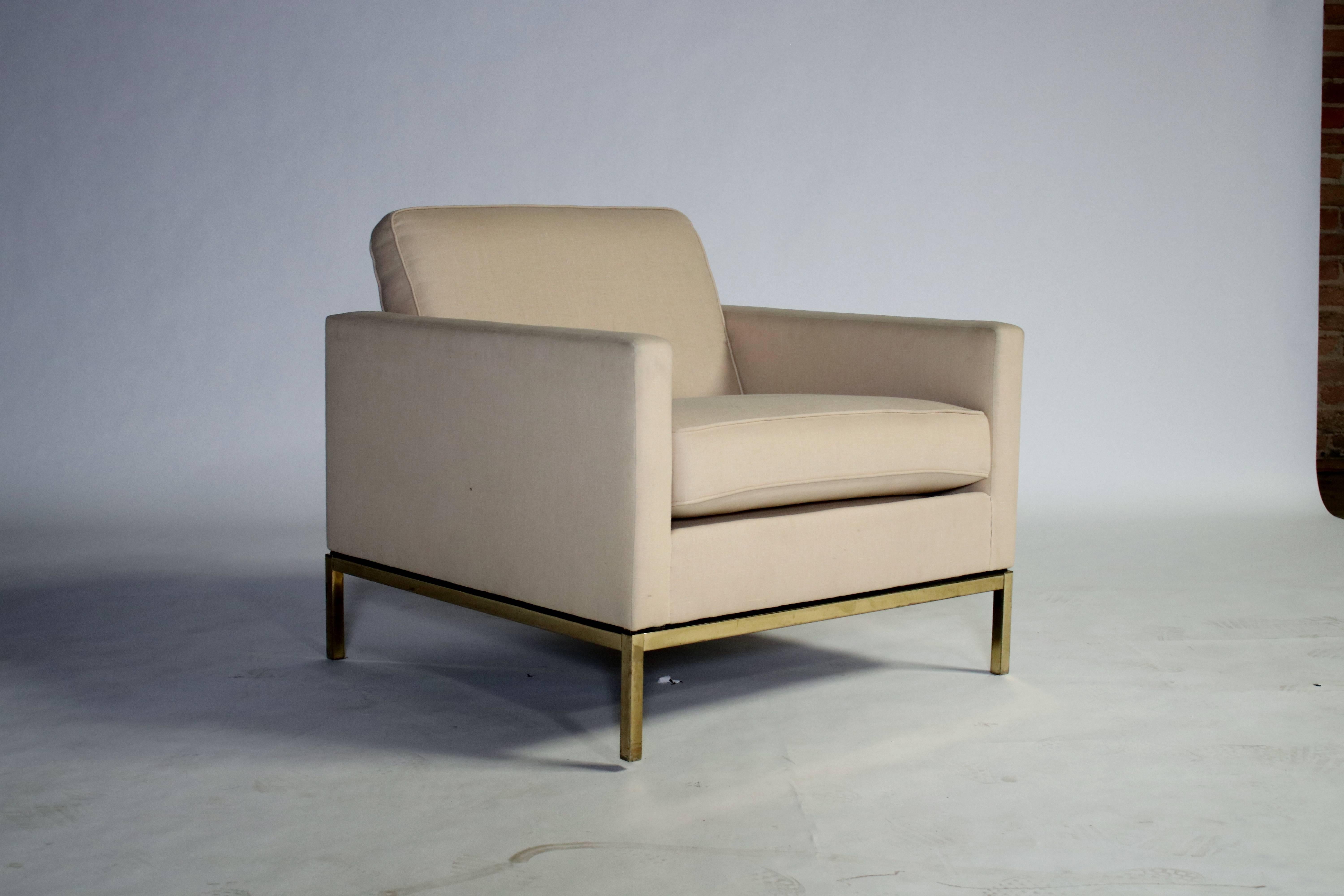 Florence Knoll armchair on a gold tone steel frame. Upholstered in a cream color linen with removable cushions.