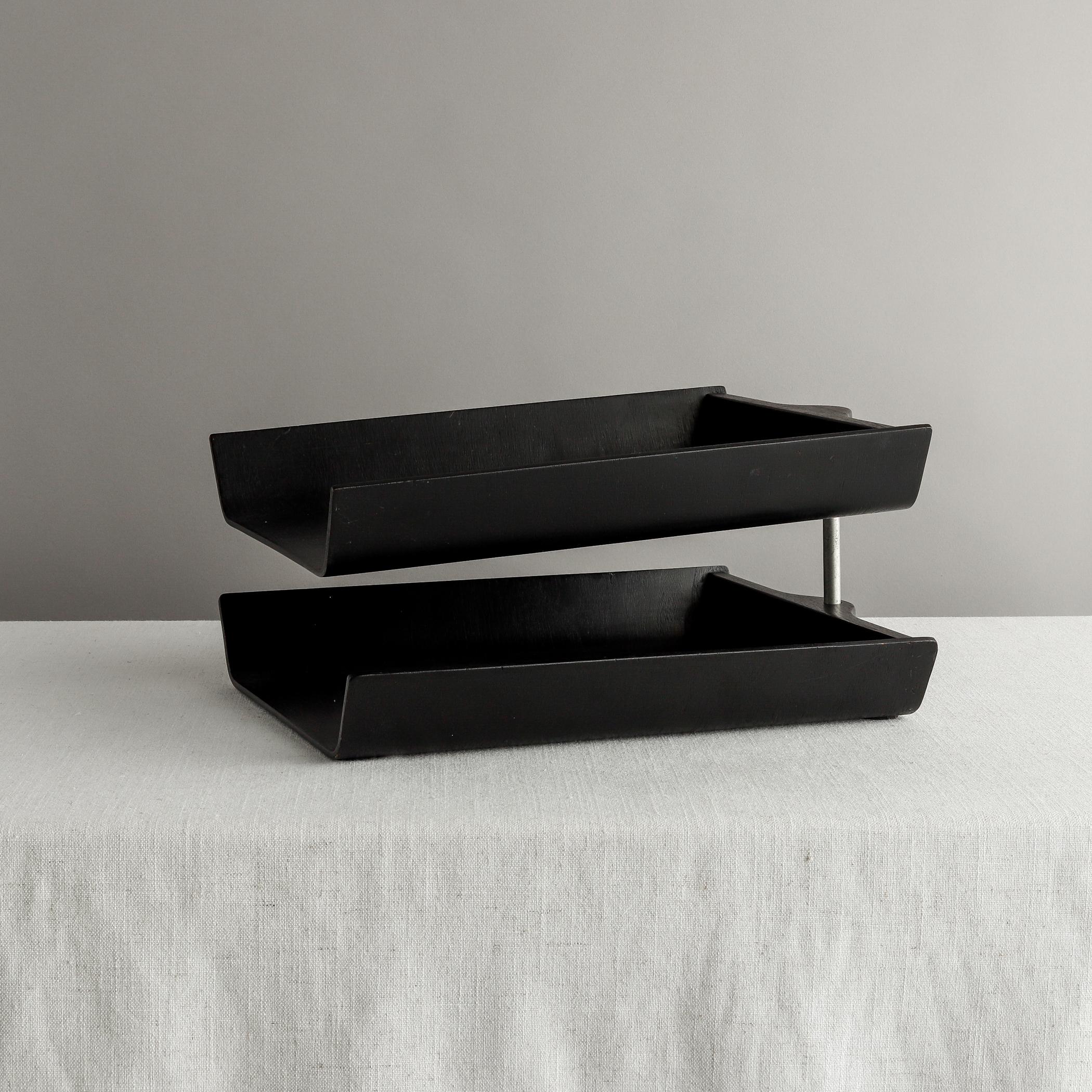 Designed by Florence Knoll in 1948, this double letter tray is made of ebonized birch plywood and was a staple of mid-century office decor. The underside of one of the two stacked trays bears Knoll label with 320 Park Avenue address, indicating