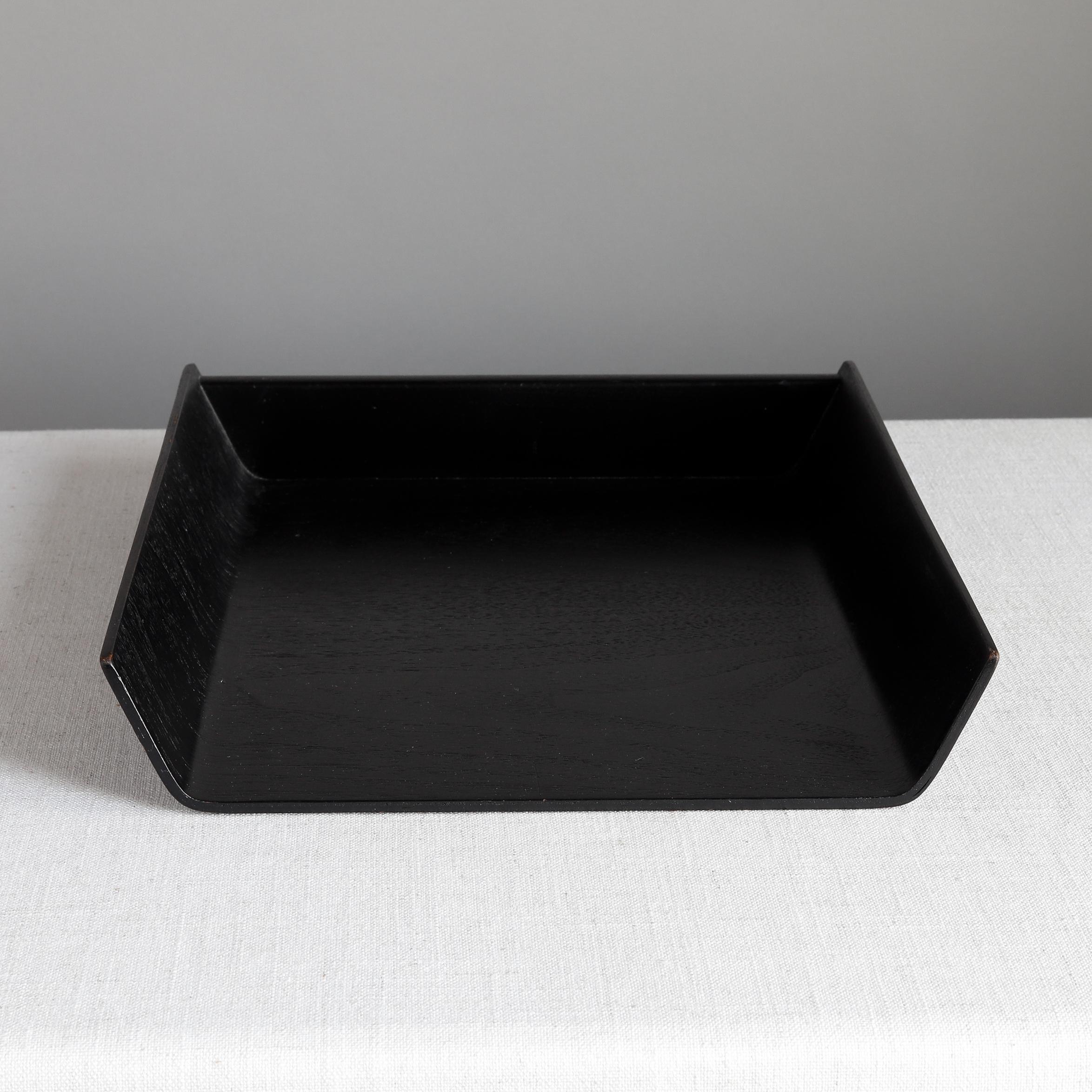 Designed by Florence Knoll in 1948, this letter tray is made of ebonized birch plywood and was a staple of midcentury office decor. The underside bears Knoll label with 320 Park Avenue address, indicating manufacture in the 1960s; also has a