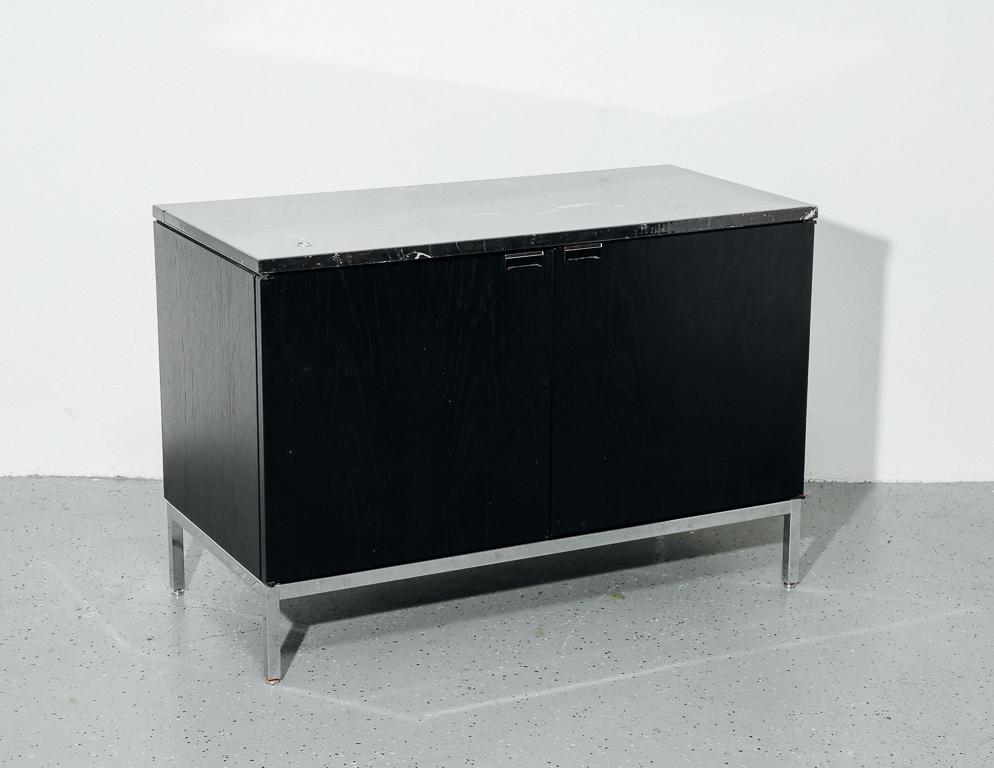 Cabinet designed by Florence Knoll for Knoll. Black marble top with ebony stained cabinet on chrome legs. Locking doors include original Knoll keys.