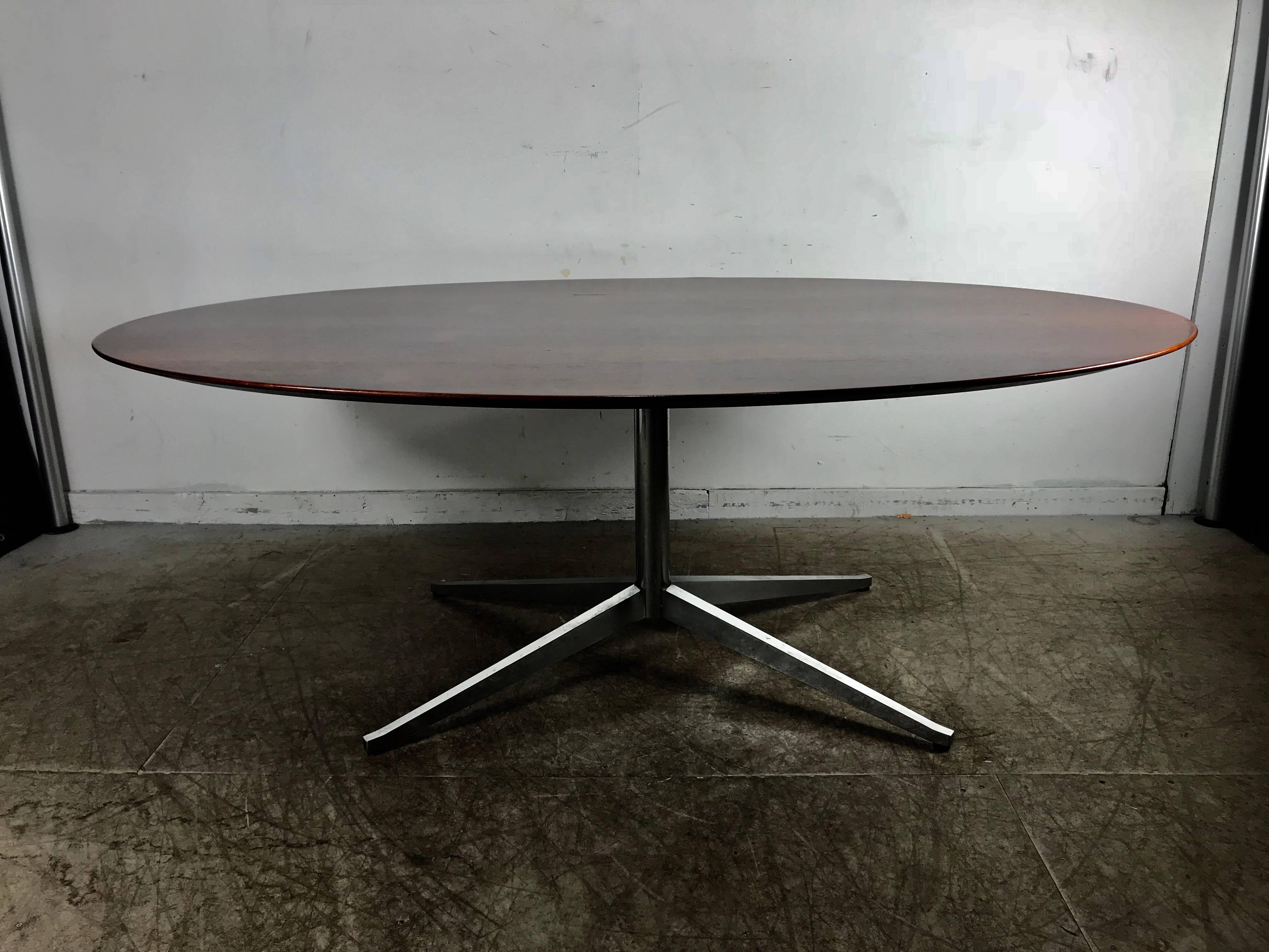 Florence Knoll conference or dining table, rosewood top for Knoll. Stunning example of a Classic Mid-Century Modern design, richly grained bookmatched rosewood.