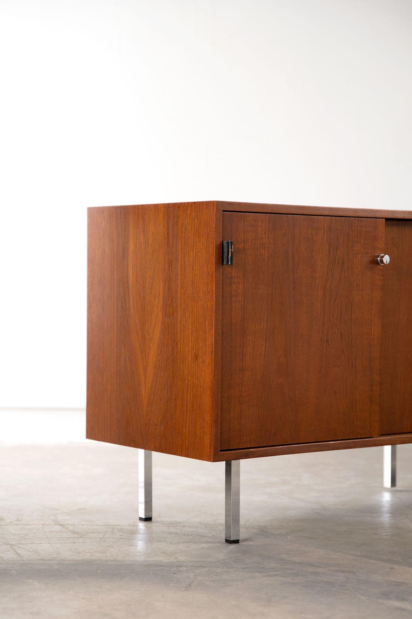 Early production, locking Credenza with teak exterior and oak interior designed by Florence Knoll for Knoll & Associates. 
This is a beautiful example that has been refinished to the highest possible standard.