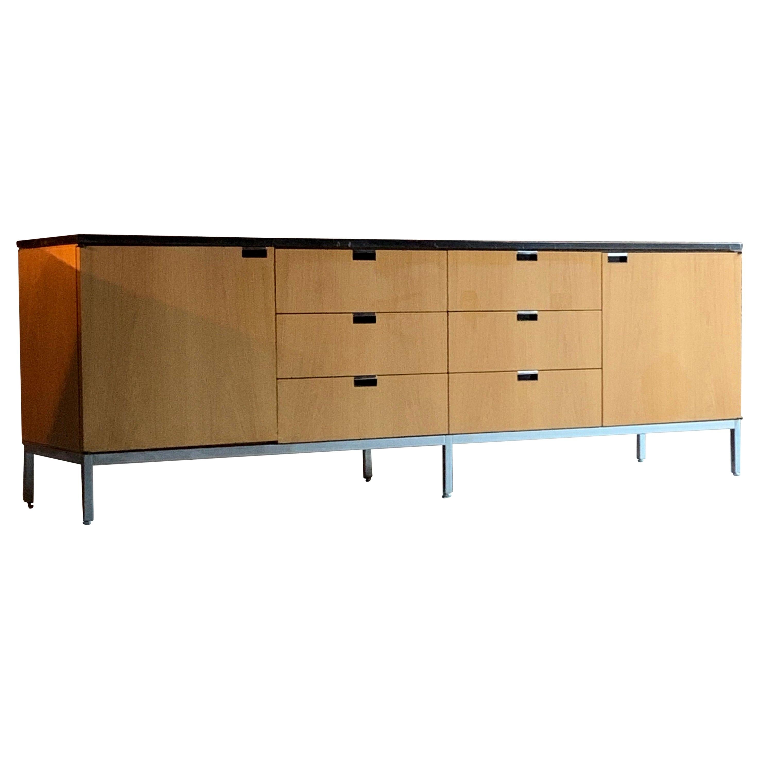 Florence Knoll credenza, a natural oak with Nero Marquina black marble credenza for Knoll Studio circa 1970s, the rectangular black marble top, above an arrangement of six drawers flanked by two cupboard doors with four adjustable shelves, raised on