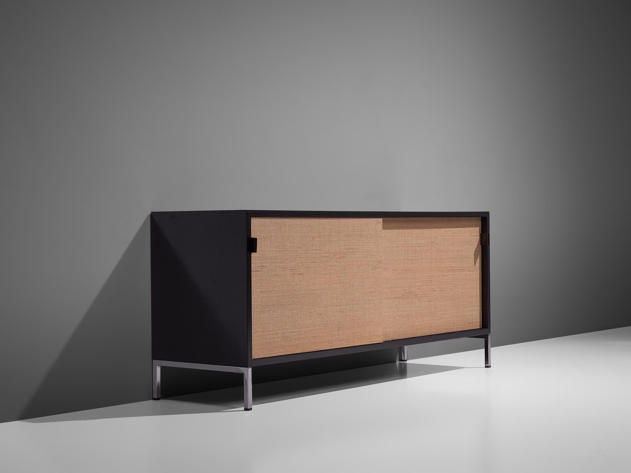 Florence Knoll for Knoll, sideboard, cane, ebonized wood, and metal, United States, design 1961, production later.

This sideboard is designed by Florence Knoll for Knoll International and was meant for the headquarters of Knoll in Italy. The