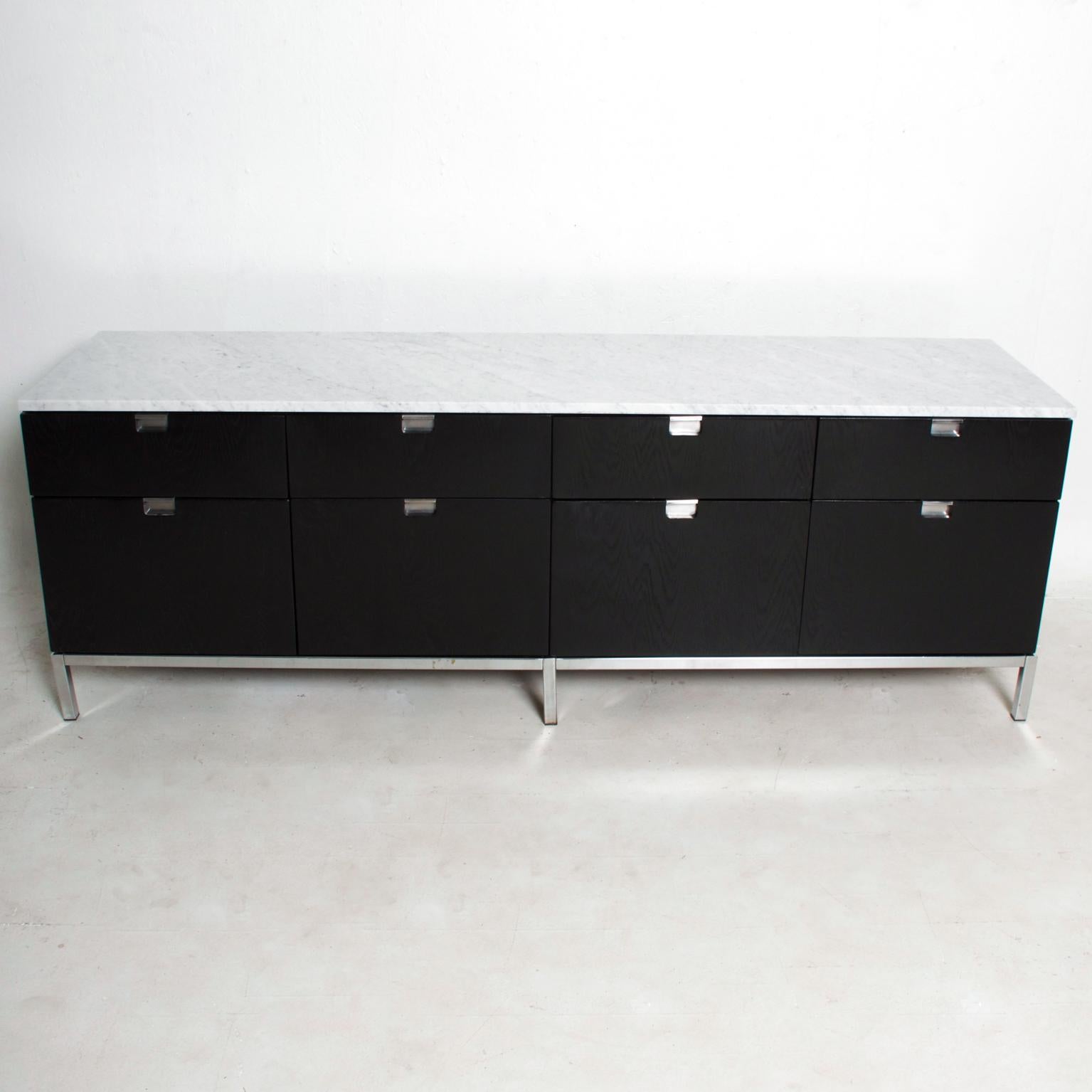 For your consideration, a Florence Knoll credenza with white Carrera marble in black oak. Stamped with knoll label in the upper drawer. Ebonized oak with white Carrera marble top. Original chrome-plated base. Finished on the back. Dimensions: