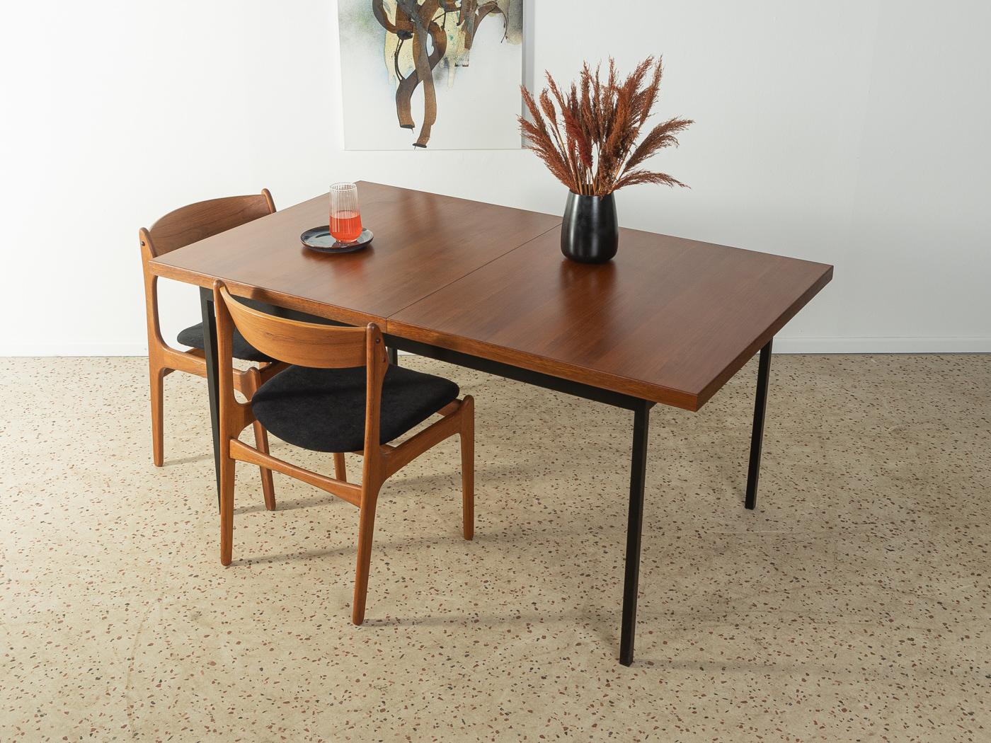 Rare extendable dining table from the 1960s by Florence Knoll for Knoll Associates. Frame in black lacquered squared steel with veneered top in teak.
Table bottom edge 74 cm
Width extended 226 cm 

Quality Features:
 very good workmanship
