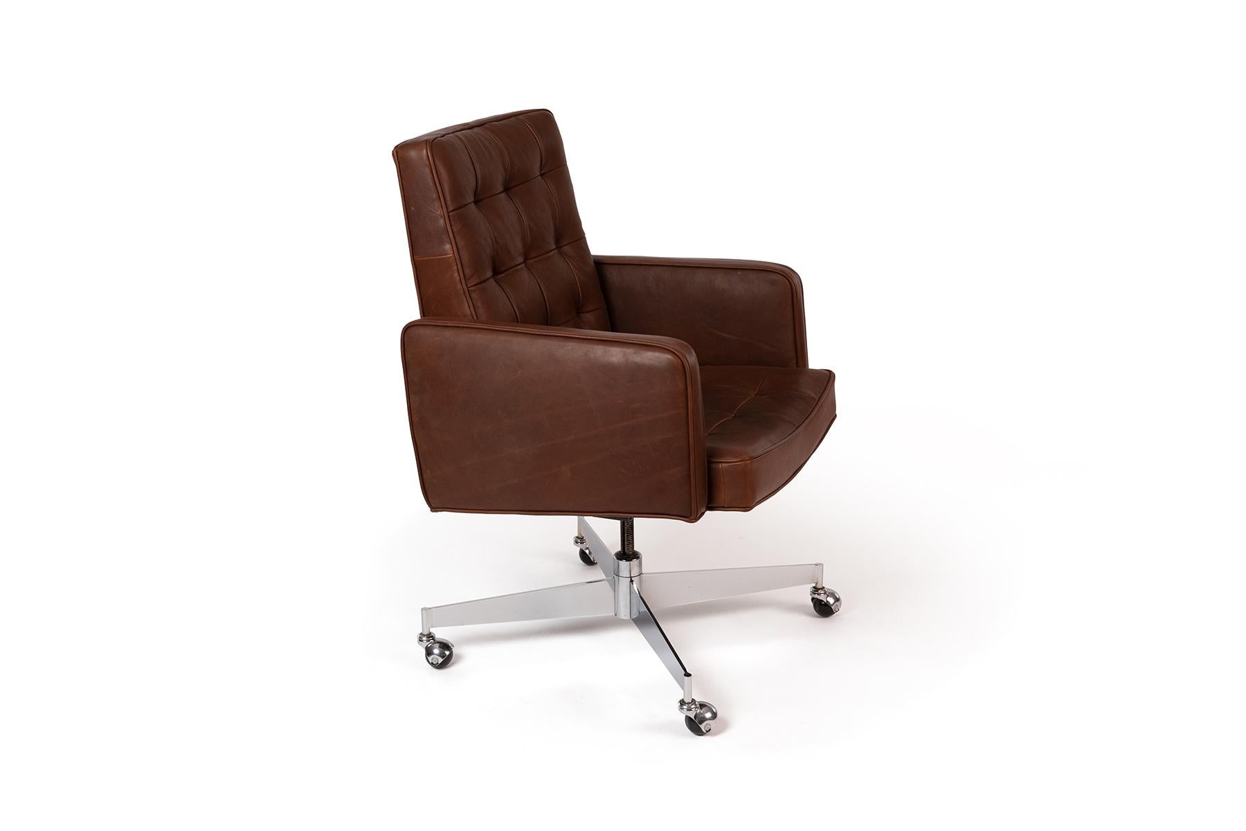 Button-tufted brown leather office chair by designer Florence Knoll for Knoll with polished steel caster wheel base. Newly upholstered.