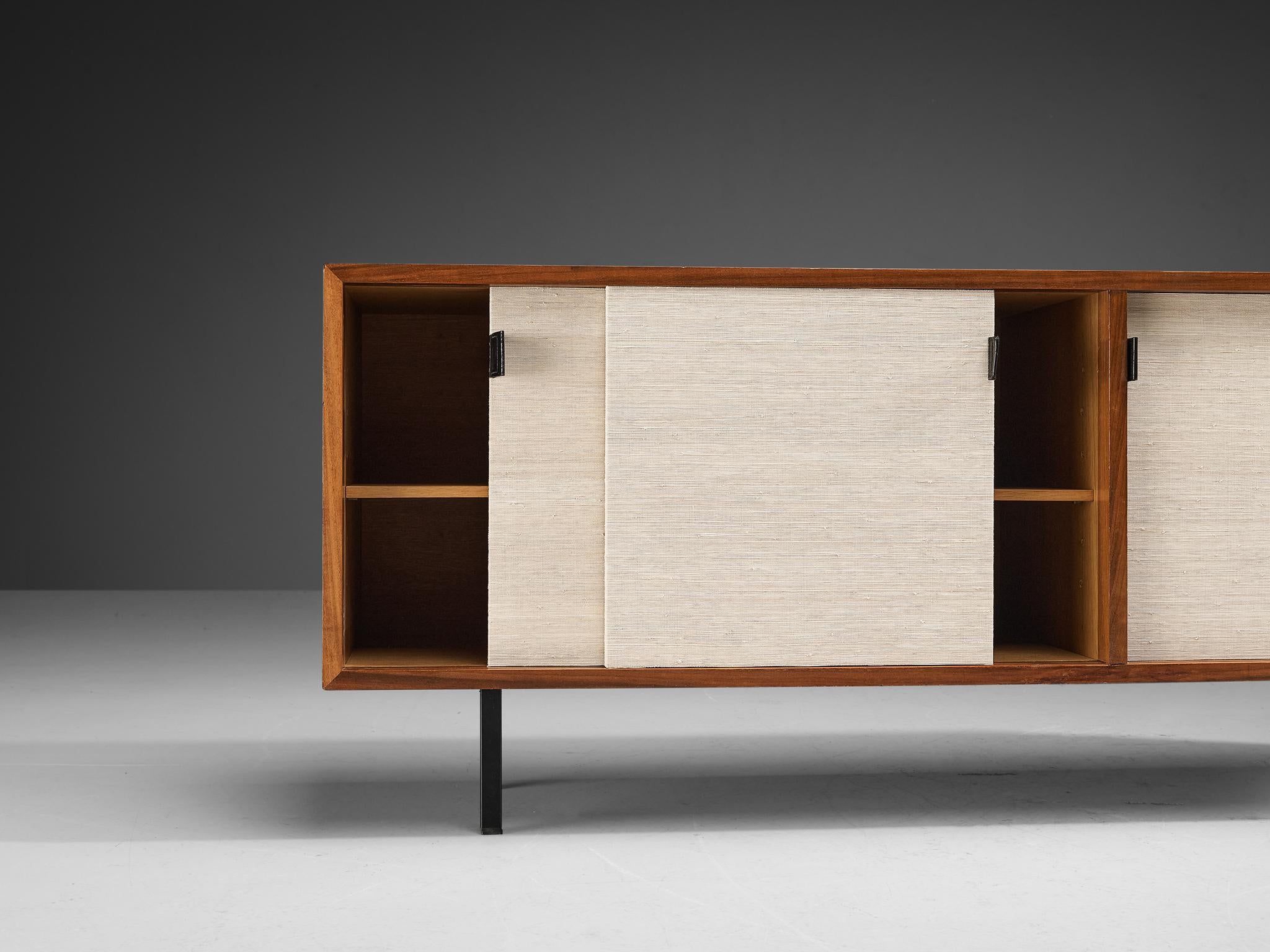 Florence Knoll for Knoll, sideboard, teak, fabric, metal, United States, ca. 1950

This sideboard is designed by Florence Knoll for Knoll International. The sideboard is executed in teak wood, with four sliding doors, leather handles, and metal