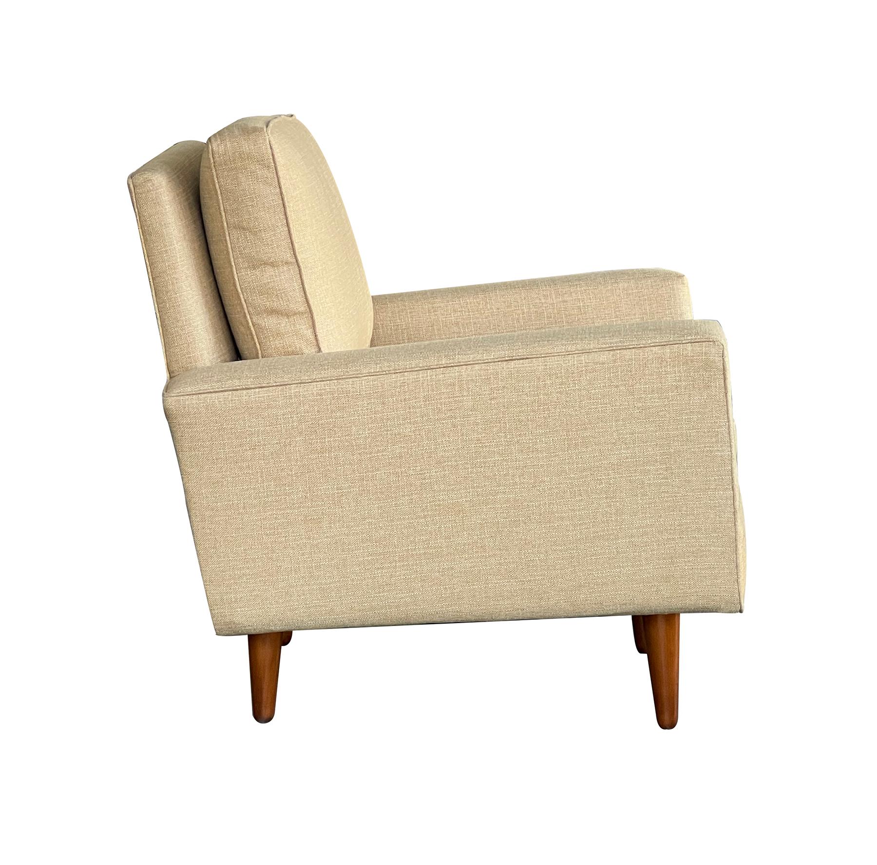 an early 1950s production Florence Knoll for Knoll International lounge chair with loose back and seat cushions all resting on four turned tapering legs