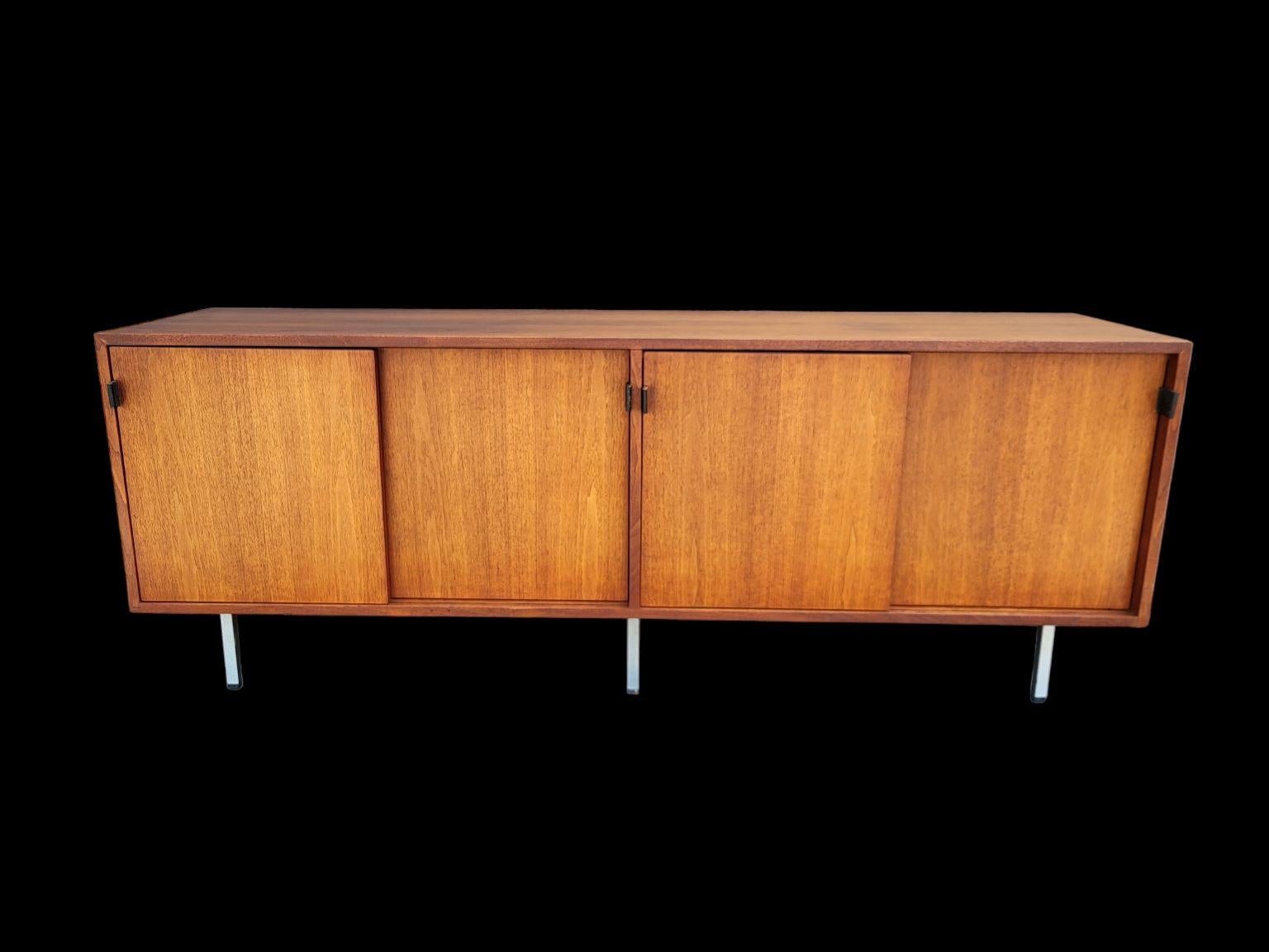 Mid Century Florence Knoll Credenza in walnut veneer case with light oak interior and black leather handles on chrome legs, marked 1963. Beautiful original condition, some wear on the leather handles, as noted in photo. Has original Knoll tag on