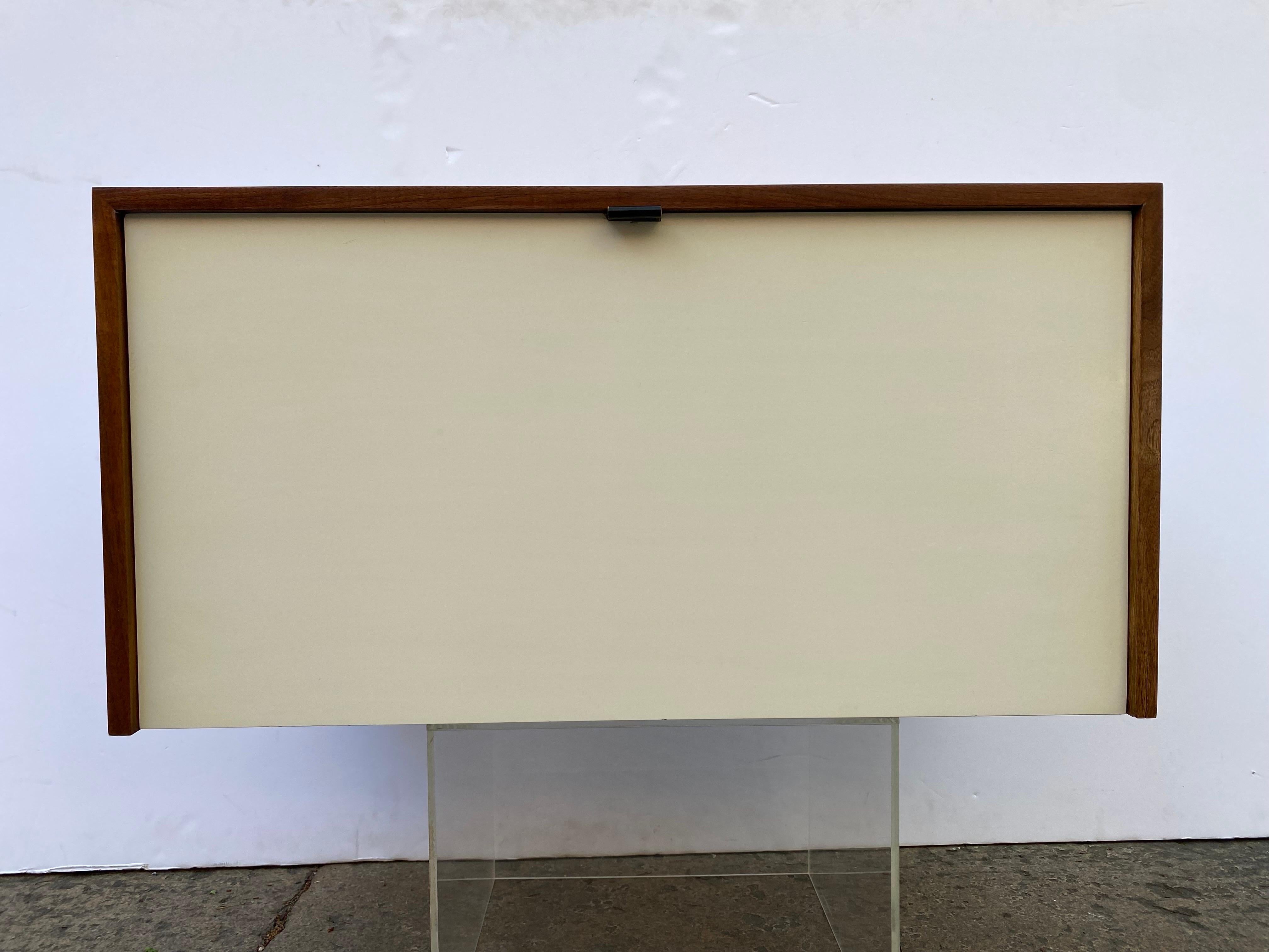 Florence Knoll for Knoll 1 Door Folding down Cabinet. 2 Available, one other one is shown in listing with legs. Cabinets were designed to hang or float from wall. There is a piece of wood across upper inside top that makes it easy to attach to the