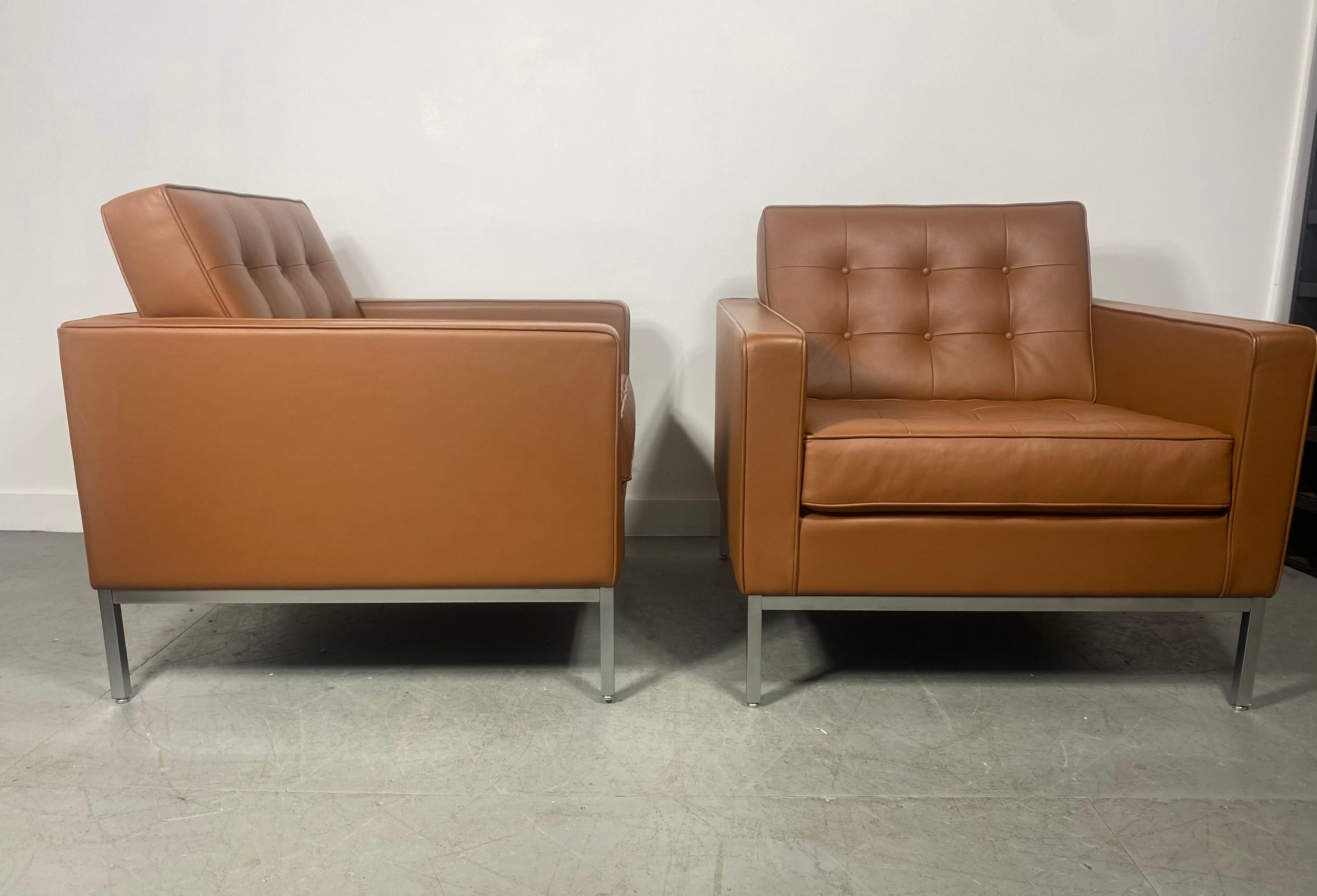 This pair of Florence Knoll leather lounge chairs for Knoll Studio feature soft supple leather over a stunning brushed steel base, with a Knoll Inc Labels, dated 2014, also retains Knoll repeat fabric on the underside of the seat cushions.