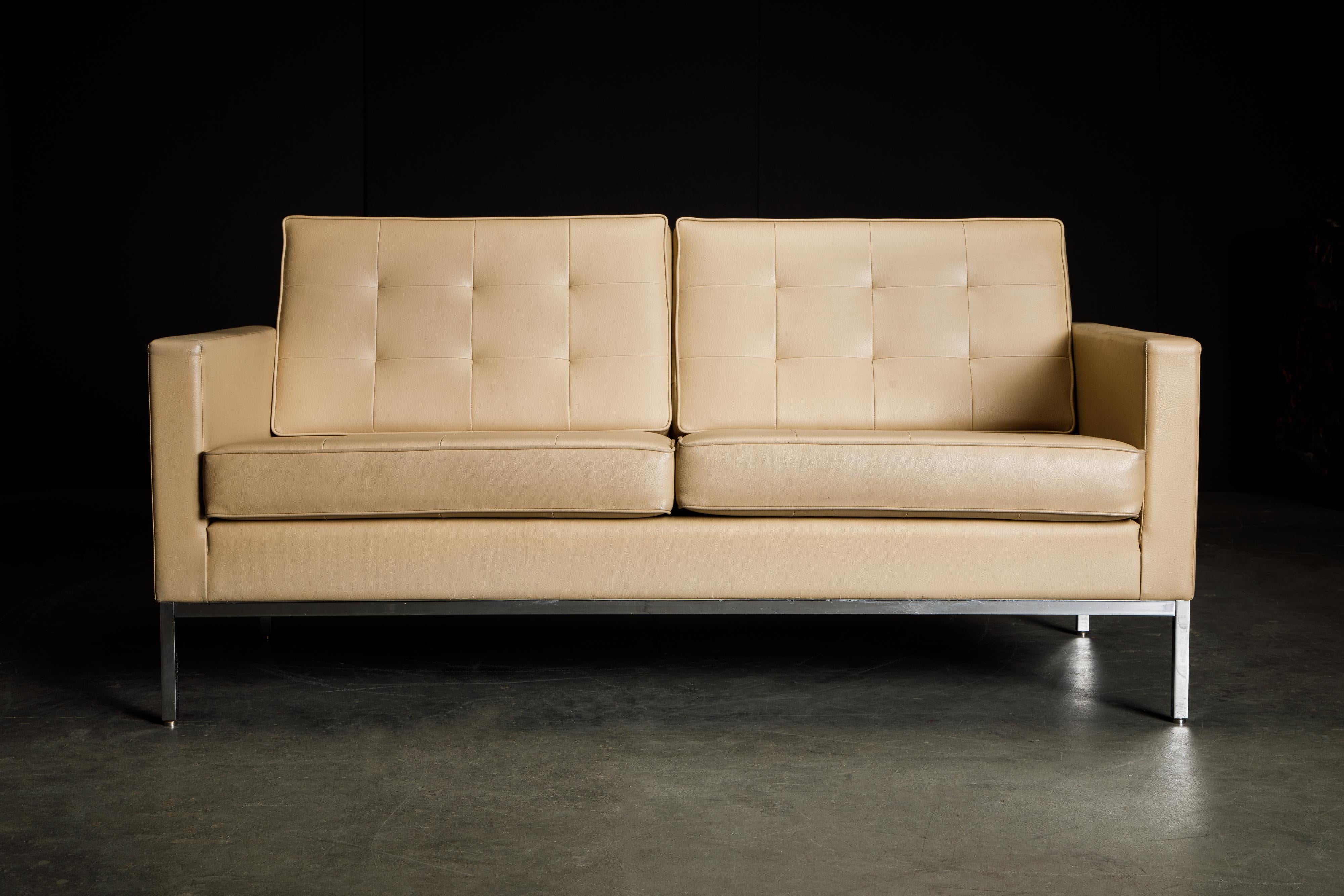 This Florence Knoll leather settee for Knoll Studio features soft supple Spinneybeck leather over a chrome base, signed with Knoll Studio logo and Florence Knoll's signature embossed on one leg, and Knoll repeat fabric on the underside of the seat