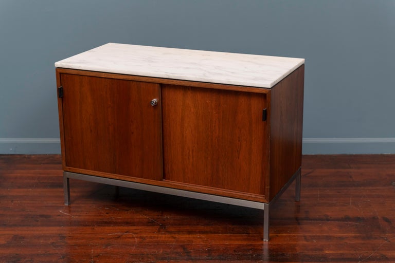 Florence Knoll rosewood and marble two door credenza on a matte brush steel base. Rare smaller size with a finished back side, no key.