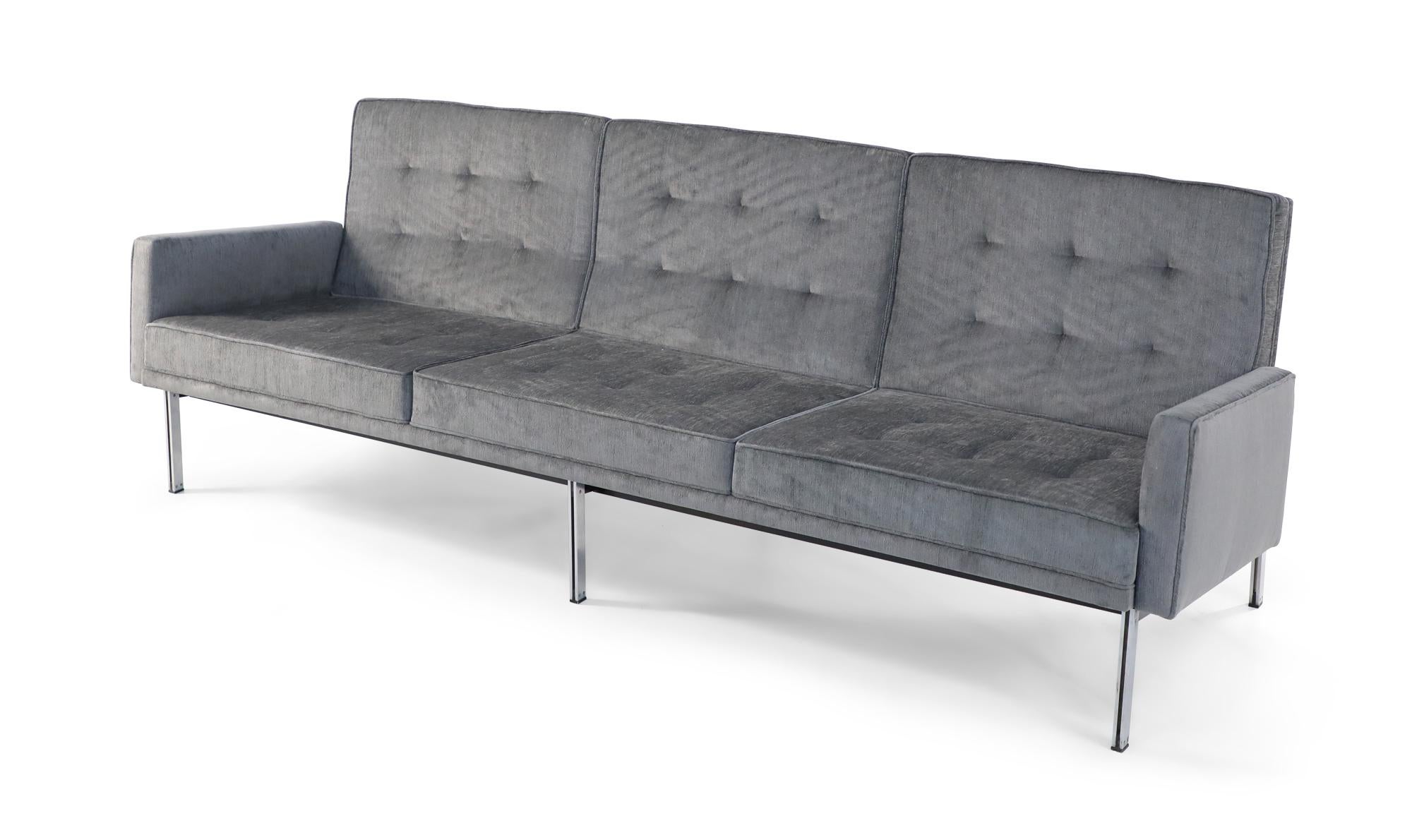 Mid-Century Modern three-seat sofa with gray sharkskin velvet upholstery, button-tufted back cushions, and a chrome-plated steel frame. (FLORENCE KNOLL).