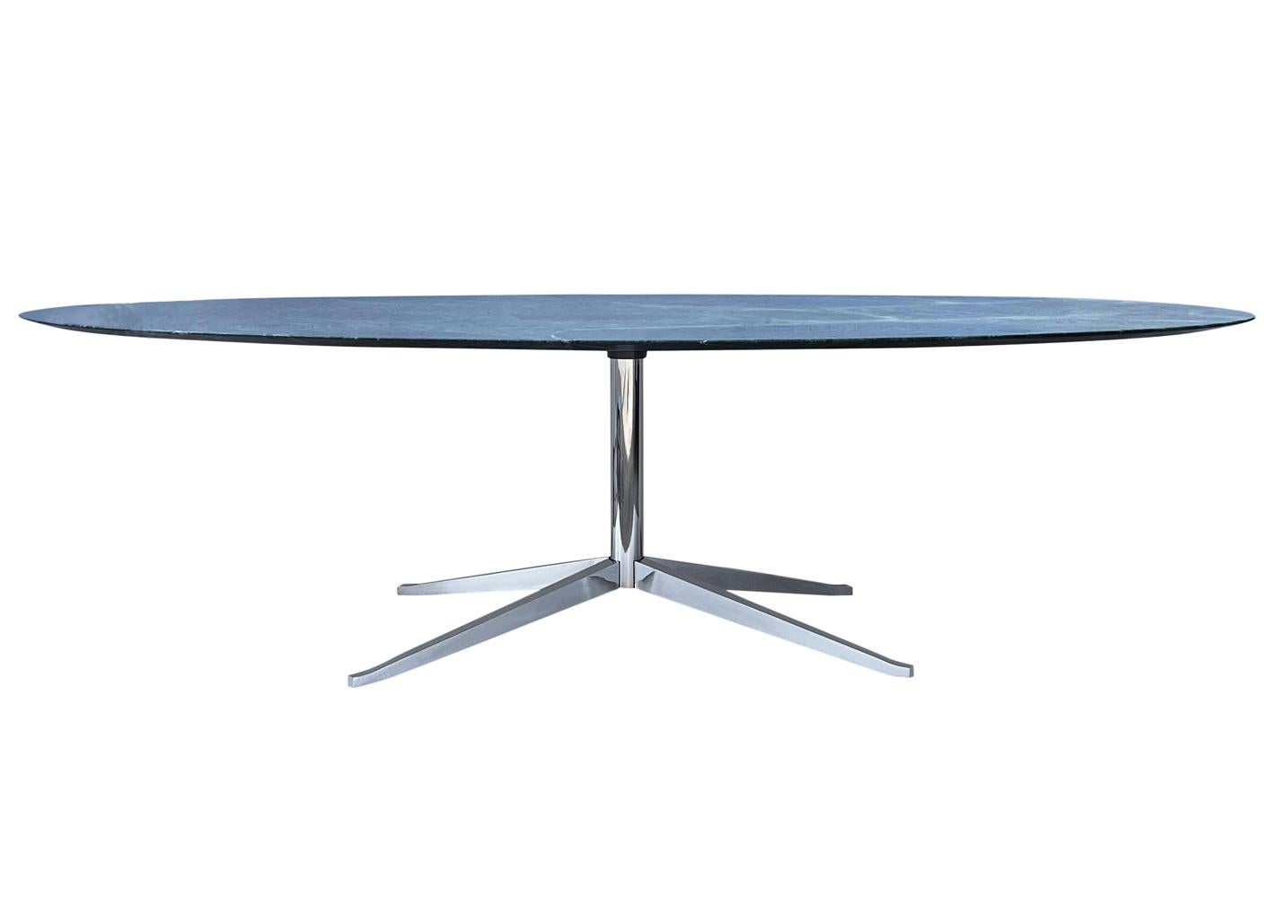 An elegant executive table designed by Florence Knoll and produced by Knoll. It features a beautiful high gloss Verde Green marble top and a chrome-plated star base. This was one of the most expensive marble options for this table. Signed twice with