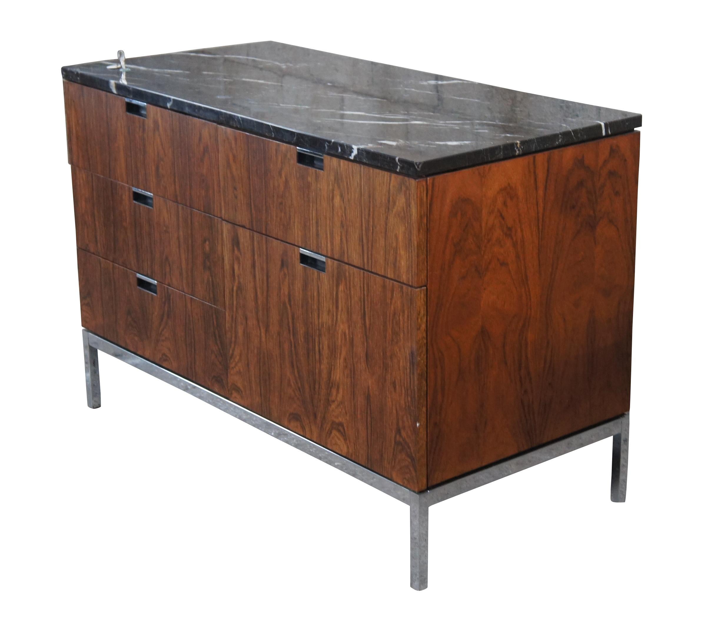 An iconic Florence Knoll petite credenza in rosewood, drawer fronts are book matched with beautiful Marquina marble top over a chrome plated steel base, circa 1960s.   Features five drawers with a locking mechanism for the left half.  

Florence