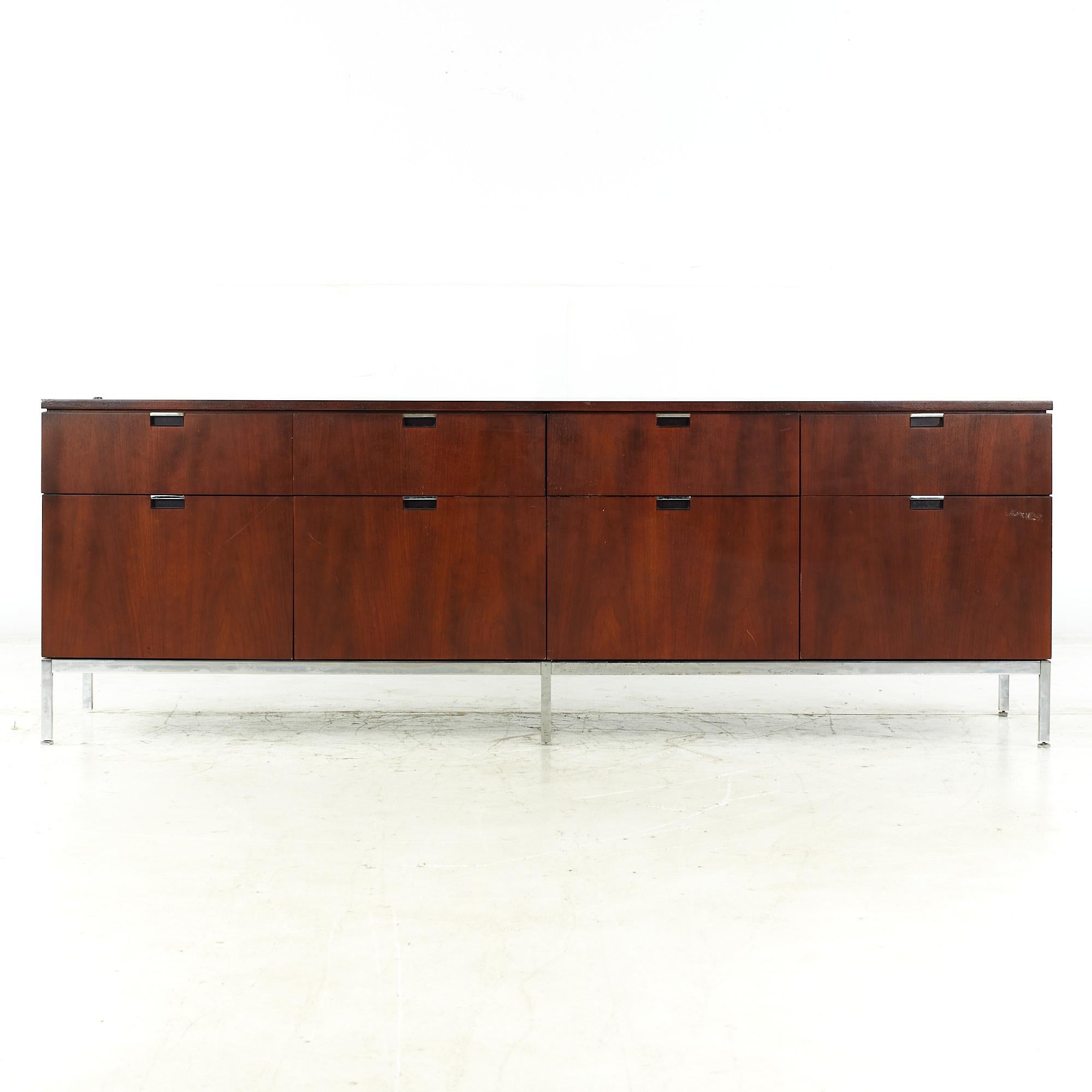Florence Knoll mid-century walnut and chrome credenza.

This credenza measures: 74.5 wide x 18 deep x 25.75 inches high.

All pieces of furniture can be had in what we call restored vintage condition. That means the piece is restored upon
