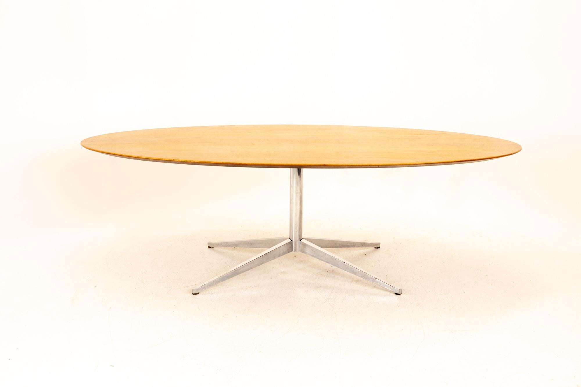Florence Knoll Mid Century walnut and chrome oval dining table
Table measures: 89.75 wide x 48 deep x 27.75 high

This piece is available in what we call restored vintage condition. Upon purchase it is fixed so it’s free of watermarks, chips or deep