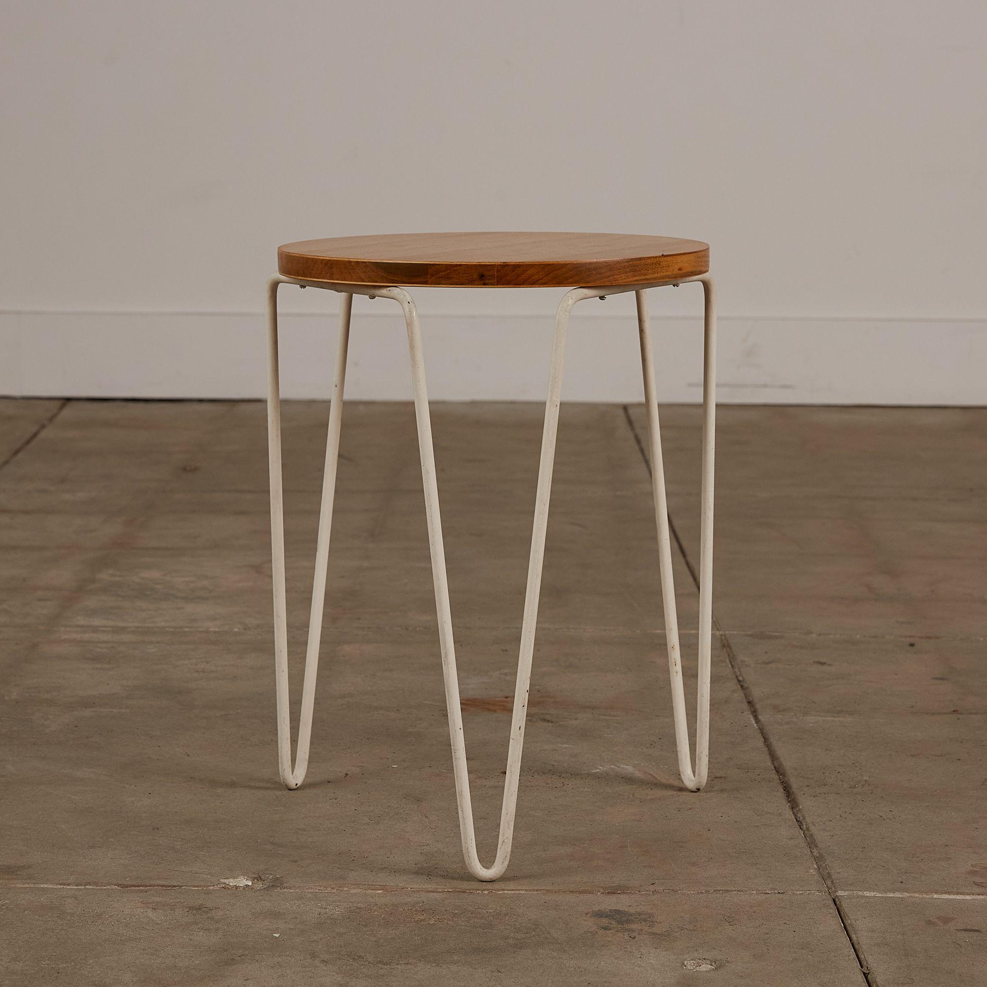 A design by Florence Knoll for Knoll International c.1940s, USA. This Model 75 stool features a birch seat atop of three white iron hairpin legs. A simplistic design that can easily be used as both a stool and side table.

Dimensions: 13” diameter