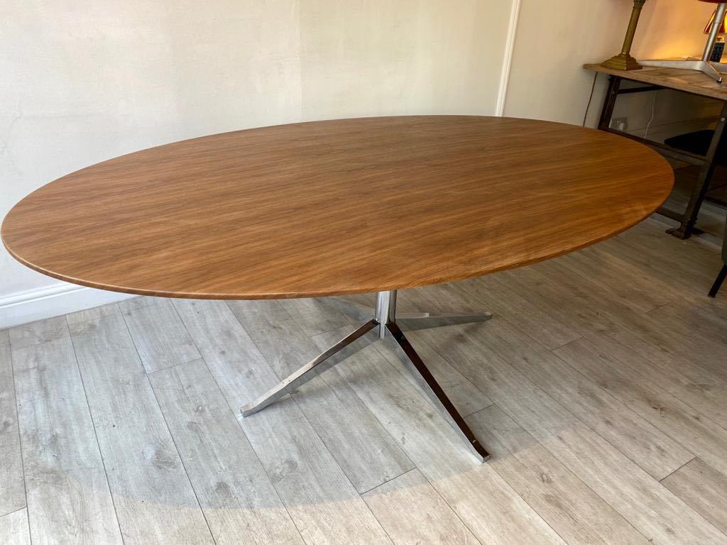 A beautiful walnut top oval dining table or meeting room table designed by Florence Knoll and manufactured by Knoll International. 

This Classic Mid-Century Modern iconic table has a chrome base oval walnut top.

Makers mark on the foot of the
