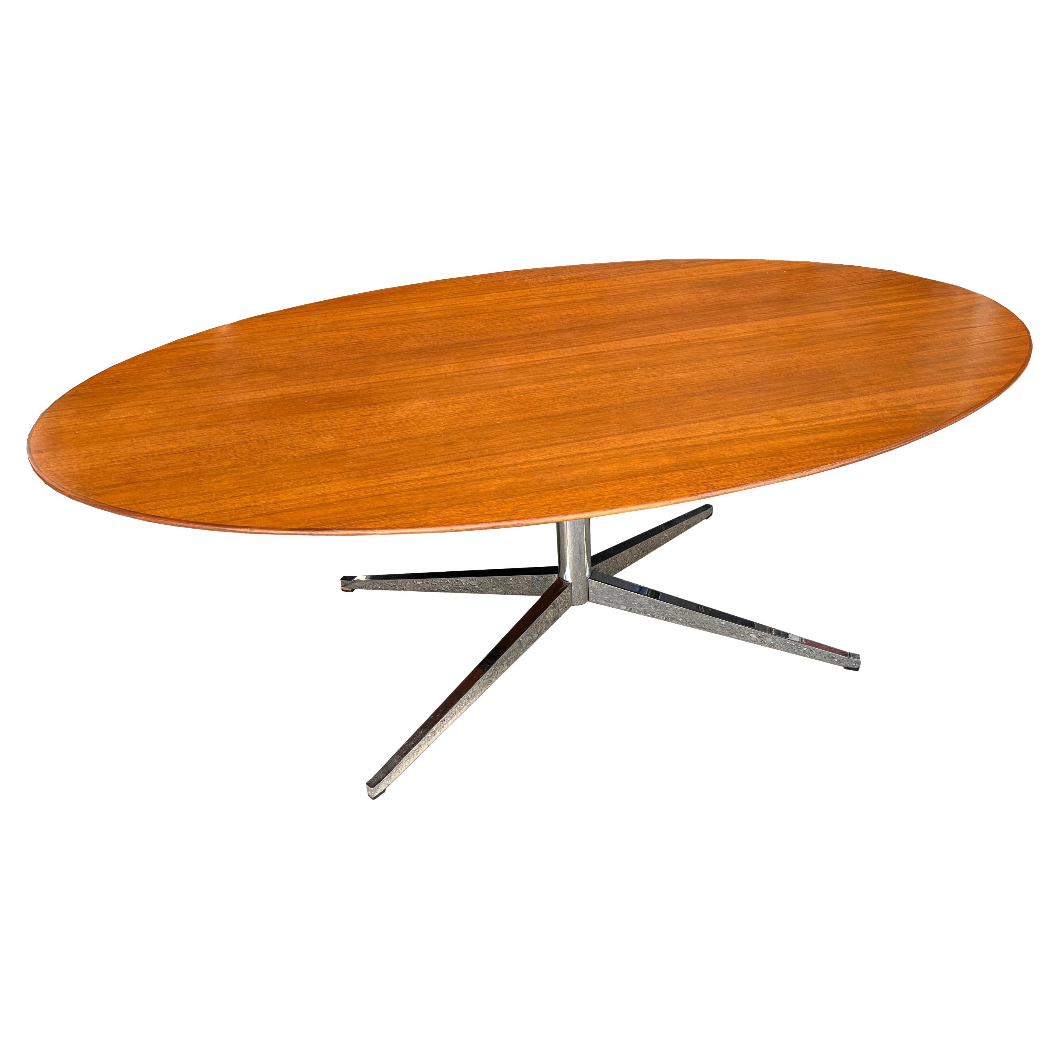 Up for sale is an iconic Florence Knoll oval table, desk, or dining table on a sold chrome-plated steel four legged base. This particular table features a walnut top. 

The table top is in nice vintage condition and has a beautiful original finish.