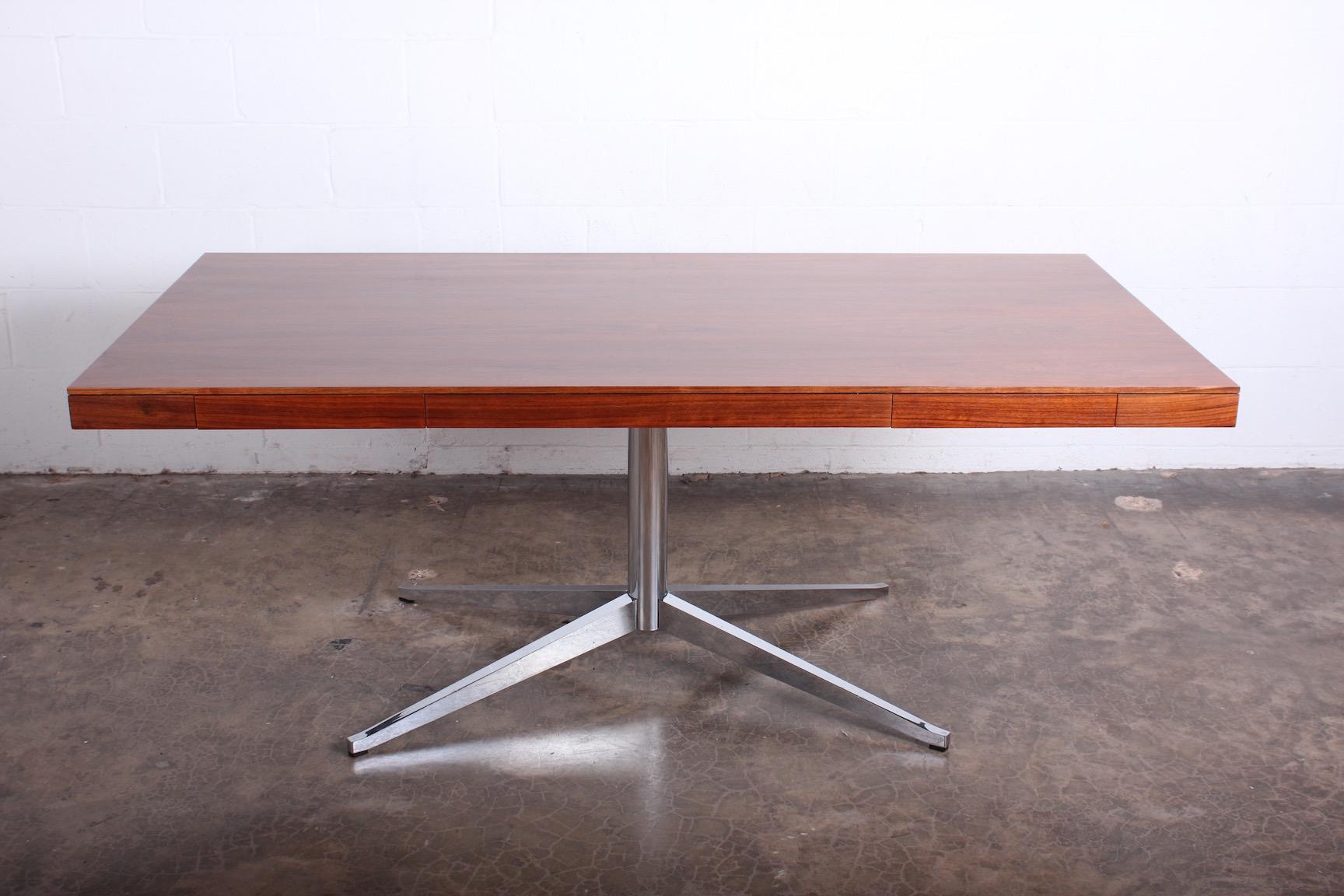 A walnut partners desk designed by Florence Knoll for Knoll.