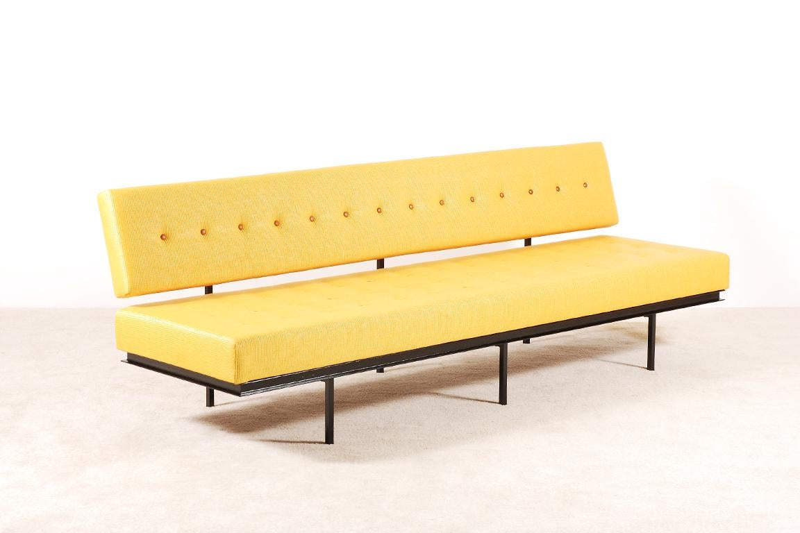 Here is a very early version of the long 578 Sofa designed by Florence Knoll for Knoll International in 1954.

Black lacquered metal structure and wooden frames with foams and fabric.

Excellent condition, newly upholstered with a yellow Raphia