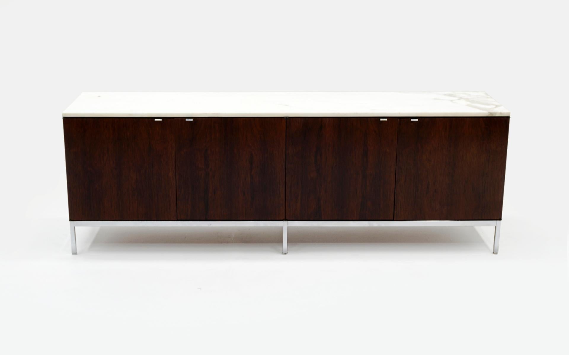 Beautiful Brazilian rosewood credenza / sideboard / storage / media cabinet on chromed steel base. Completely original and in very good condition, ready to use. The Calacatta marble (more rare and expensive than Carrara marble) is white with gray