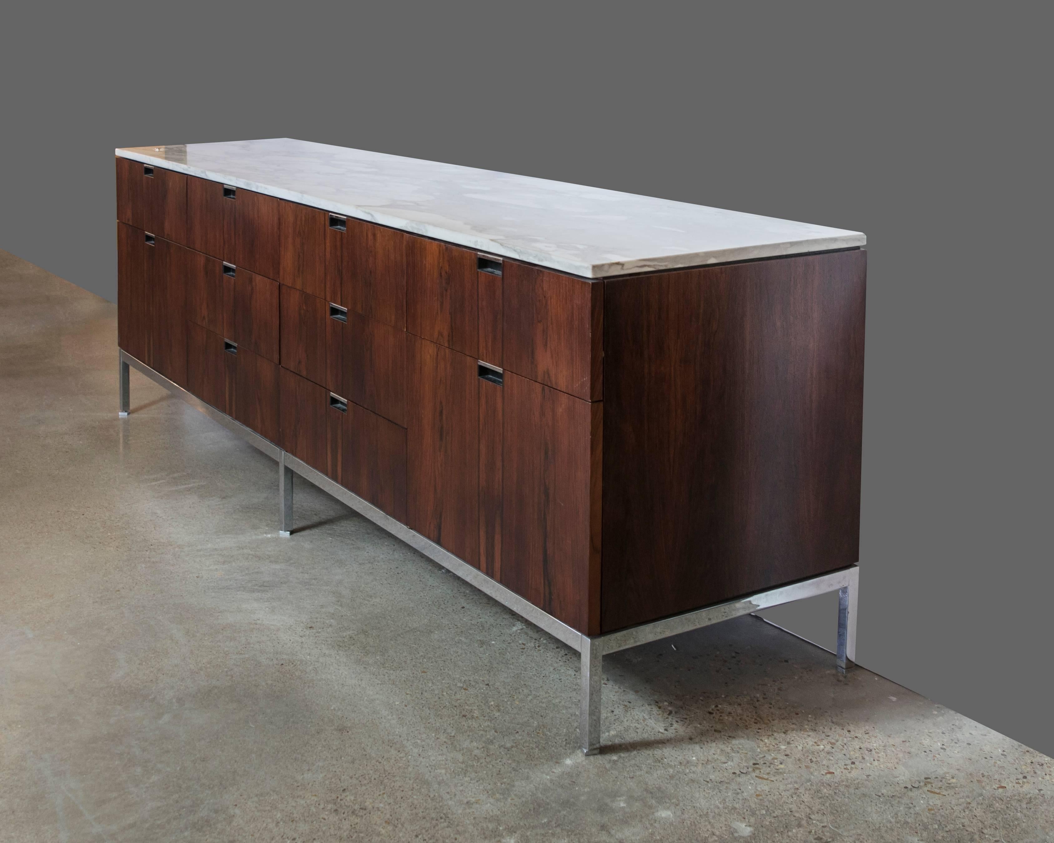 Stunning Florence Knoll credenza in rare rosewood with a Carrara marble top and a finished back that can float in a room. Chrome is in excellent condition. Very excellent condition for a piece this age.