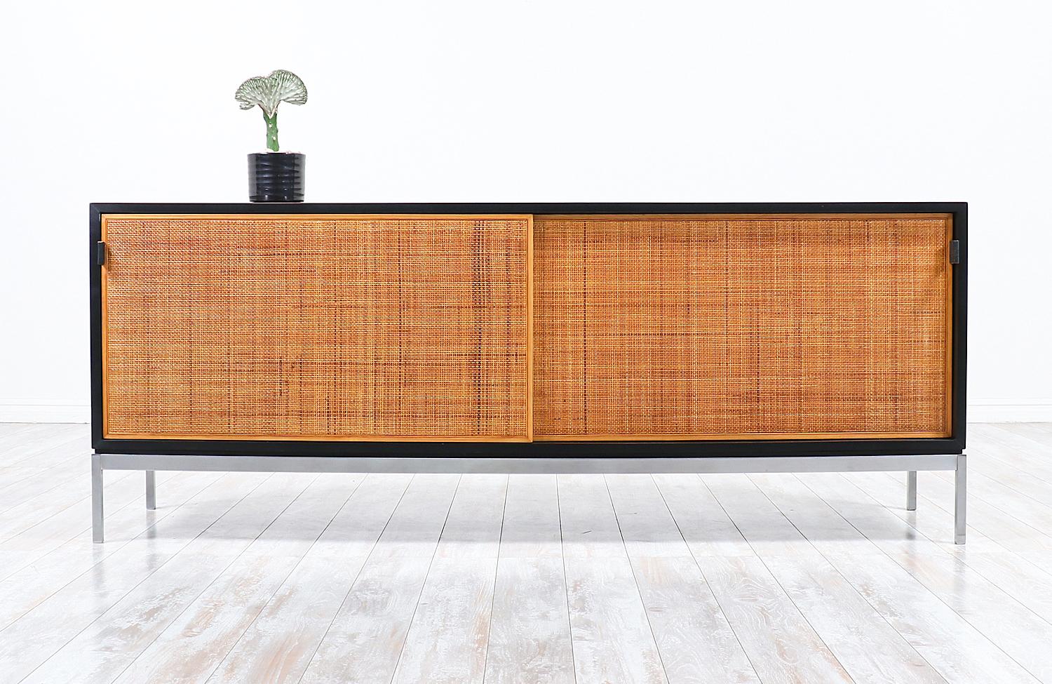 Florence Knoll rosewood credenza with original cane doors and leather pulls.