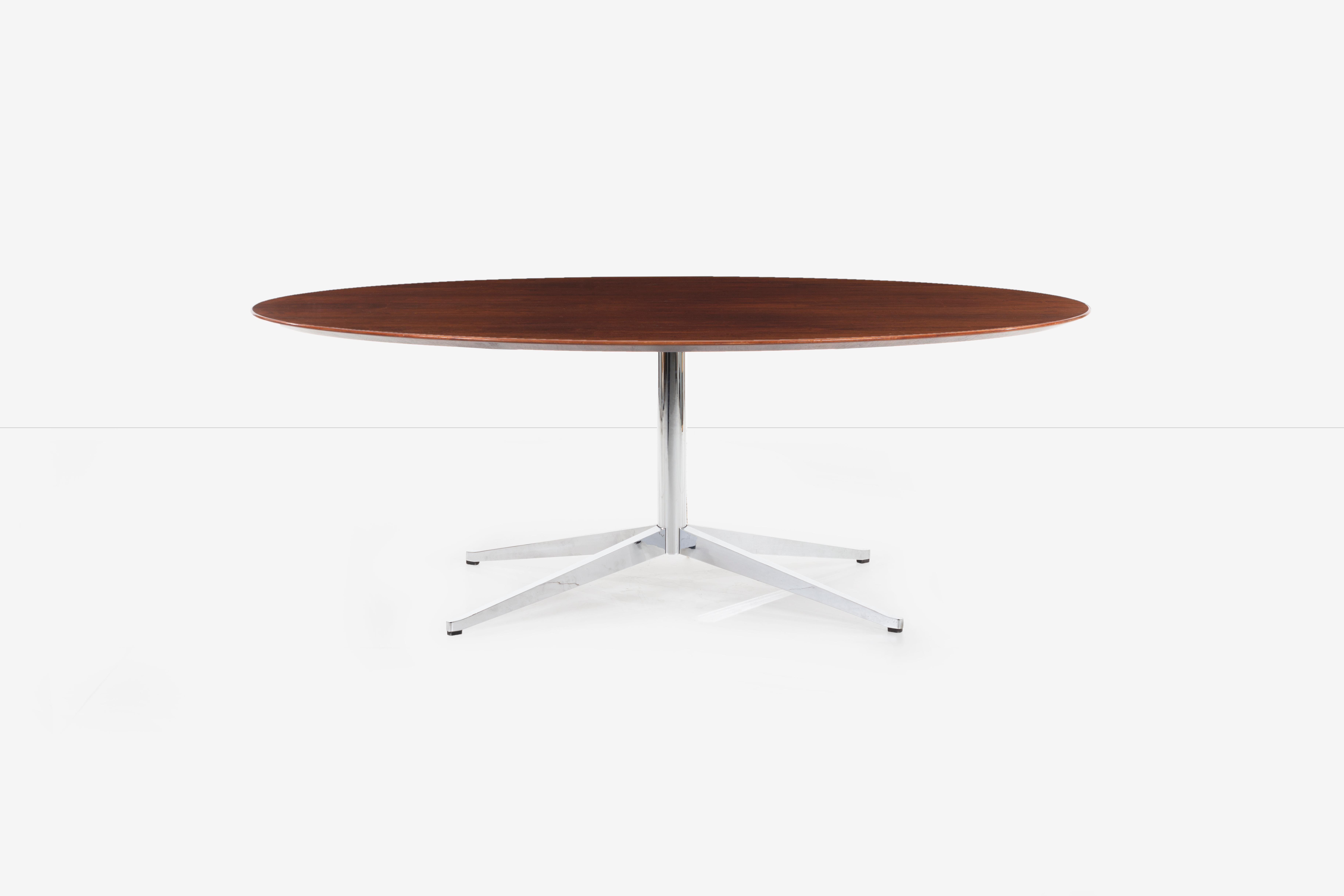 Florence Knoll rosewood dining table or desk, highly figured rosewood veneer top with beveled edge detail. Solid steel brushed chrome-plated stem and base.
[label on underside Knoll International].