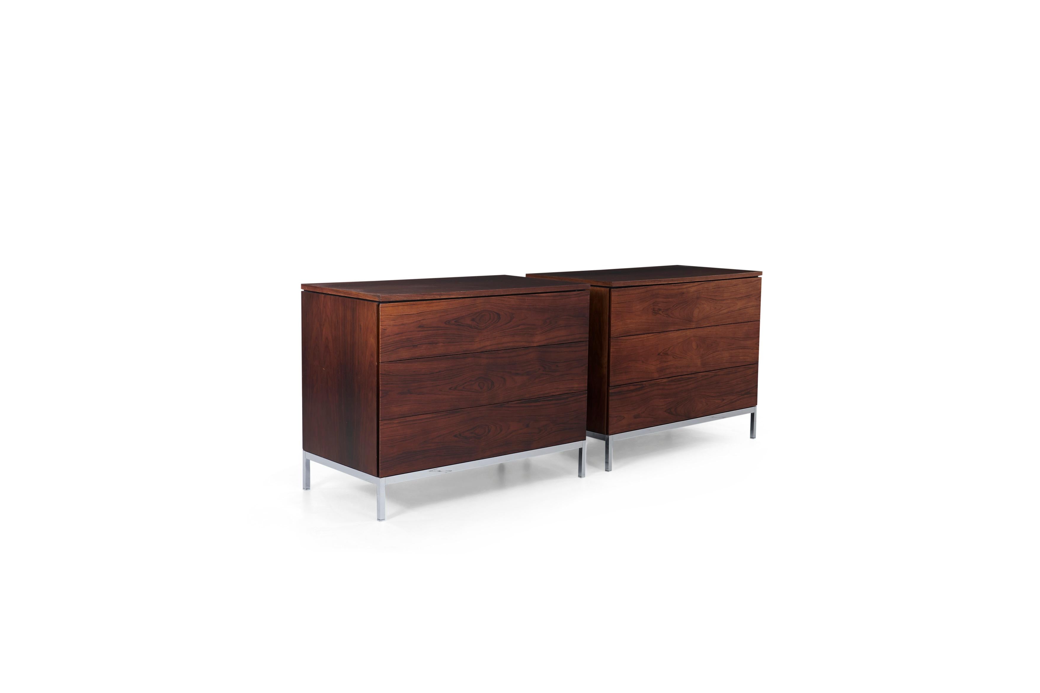 Florence Knoll for Knoll International, pair of dressers, highly figured book matched rosewood veneer, chrome plated steel base, solid steel legs with adjustable glides, 3 drawers each case, beveled edges each side of drawer function as pulls for
