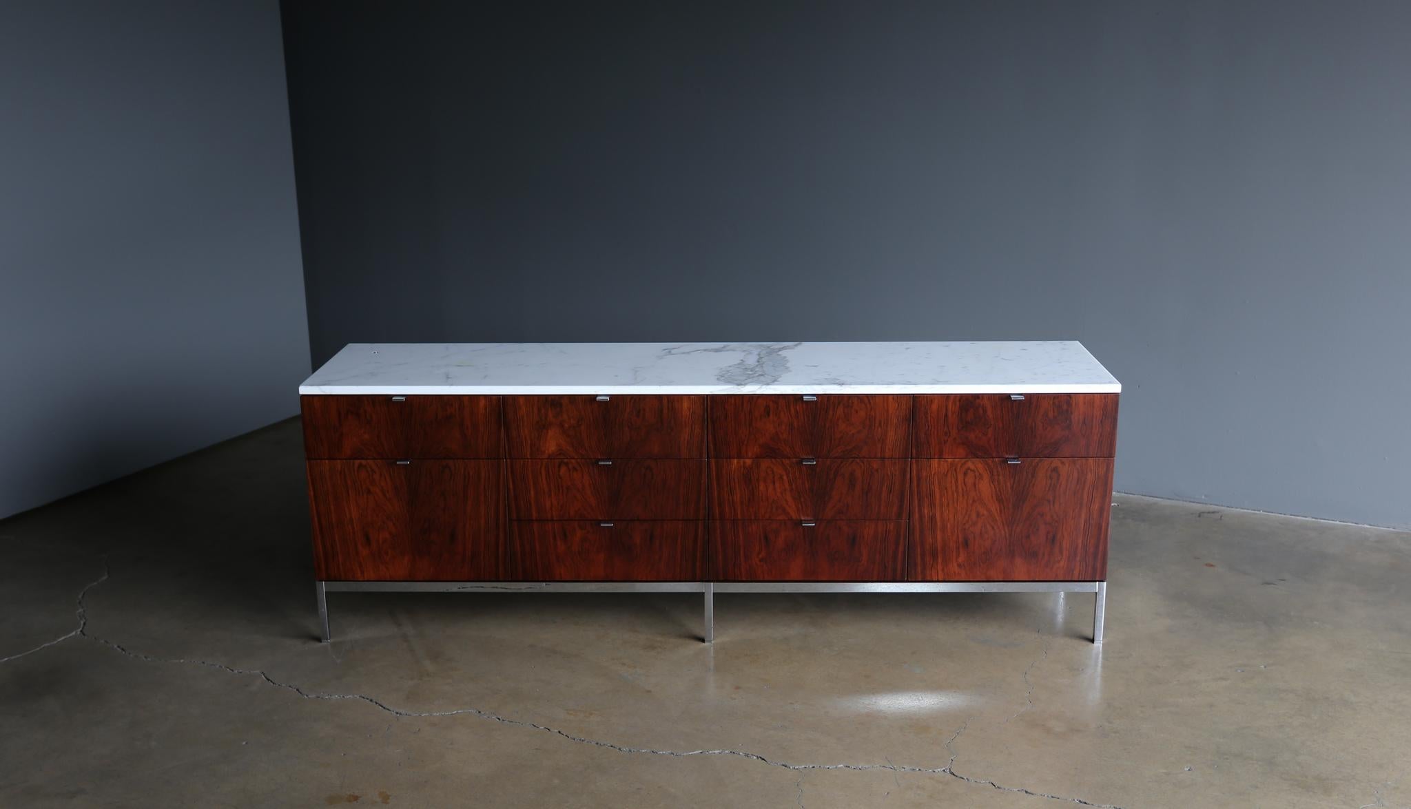 Florence Knoll rosewood & marble credenza, circa 1960. Provenance: Architect Welton Becket & Associates Office. This piece is in very good original condition. Retains a Welton Becket property control tag #2452 to the back along with a Knoll label to