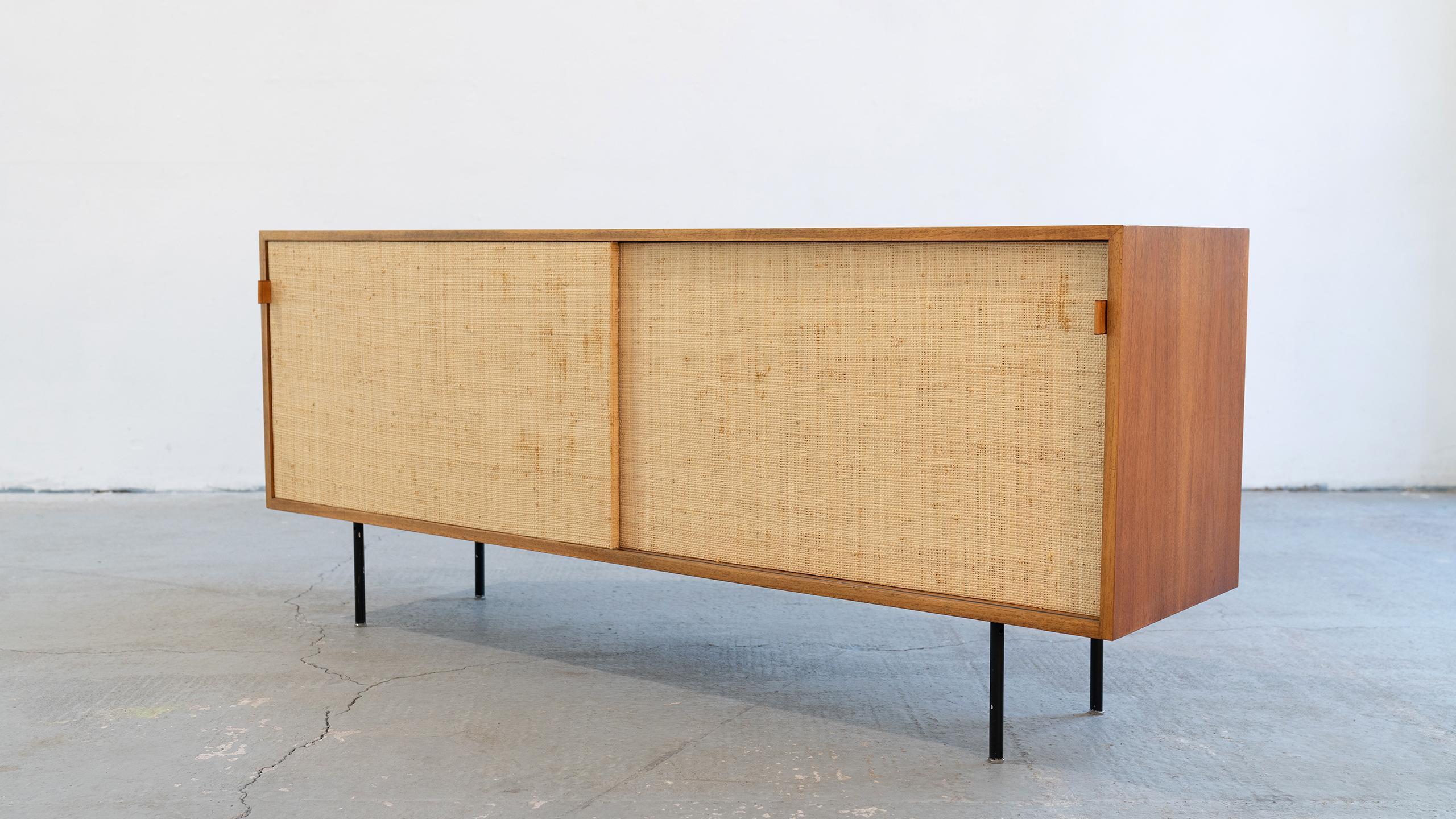Sideboard (Mod°123) from 1968, designed by Florence Knoll for Knoll International - this version was produced in 1968 by Knoll International in Stuttgart.

The sliding doors are woven with Seagrass, a beautiful, warm and subtle detail. 
Stitched