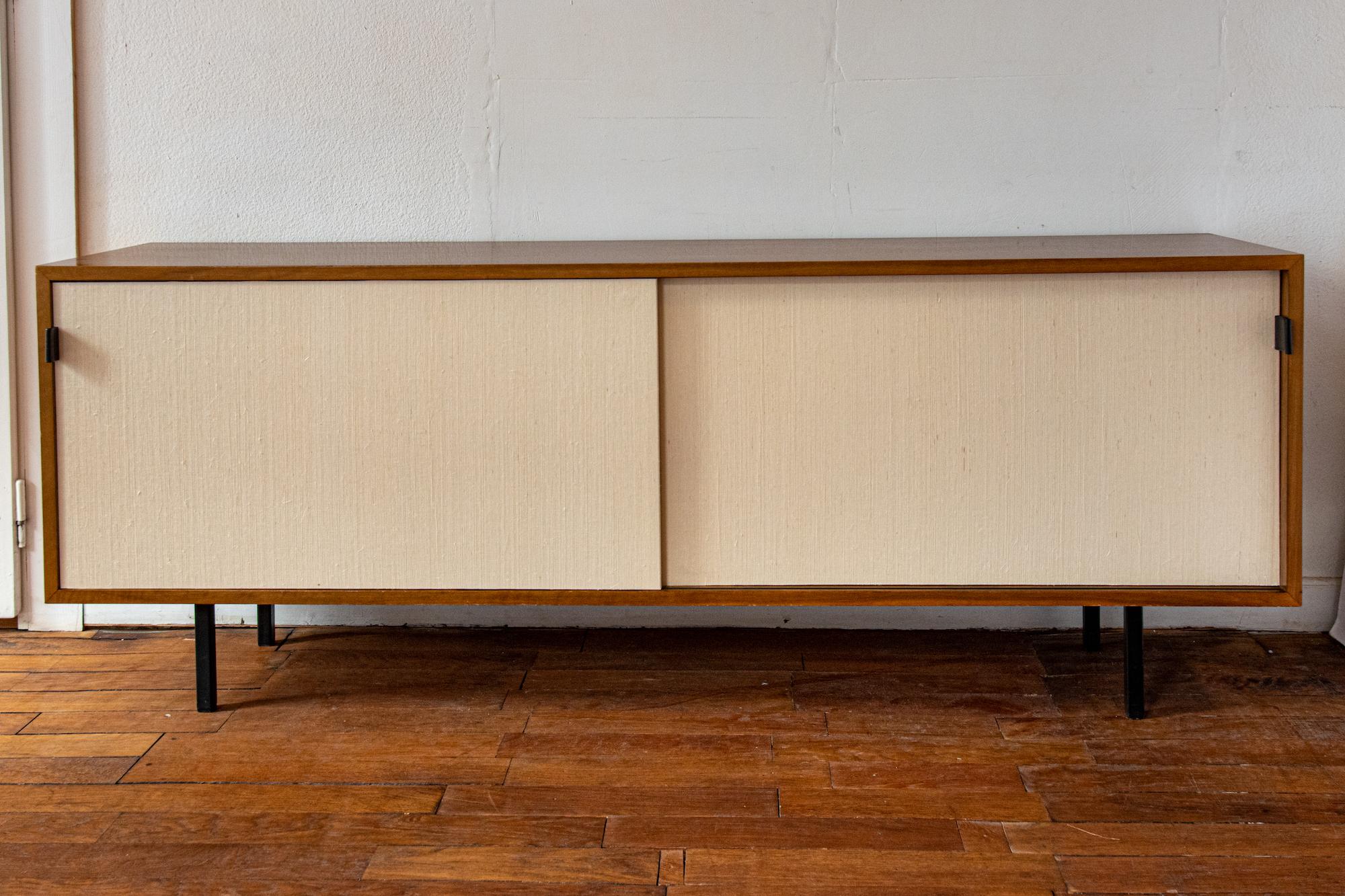 Neat and rare Florence Knoll sideboard, Made in Switzerland by Wohnbedarf for Knoll International, circa 1968. 
Walnut wood,  sliding doors with seagrass, leather handles, black metal legs.
Nice patina, very well preserved original condition.