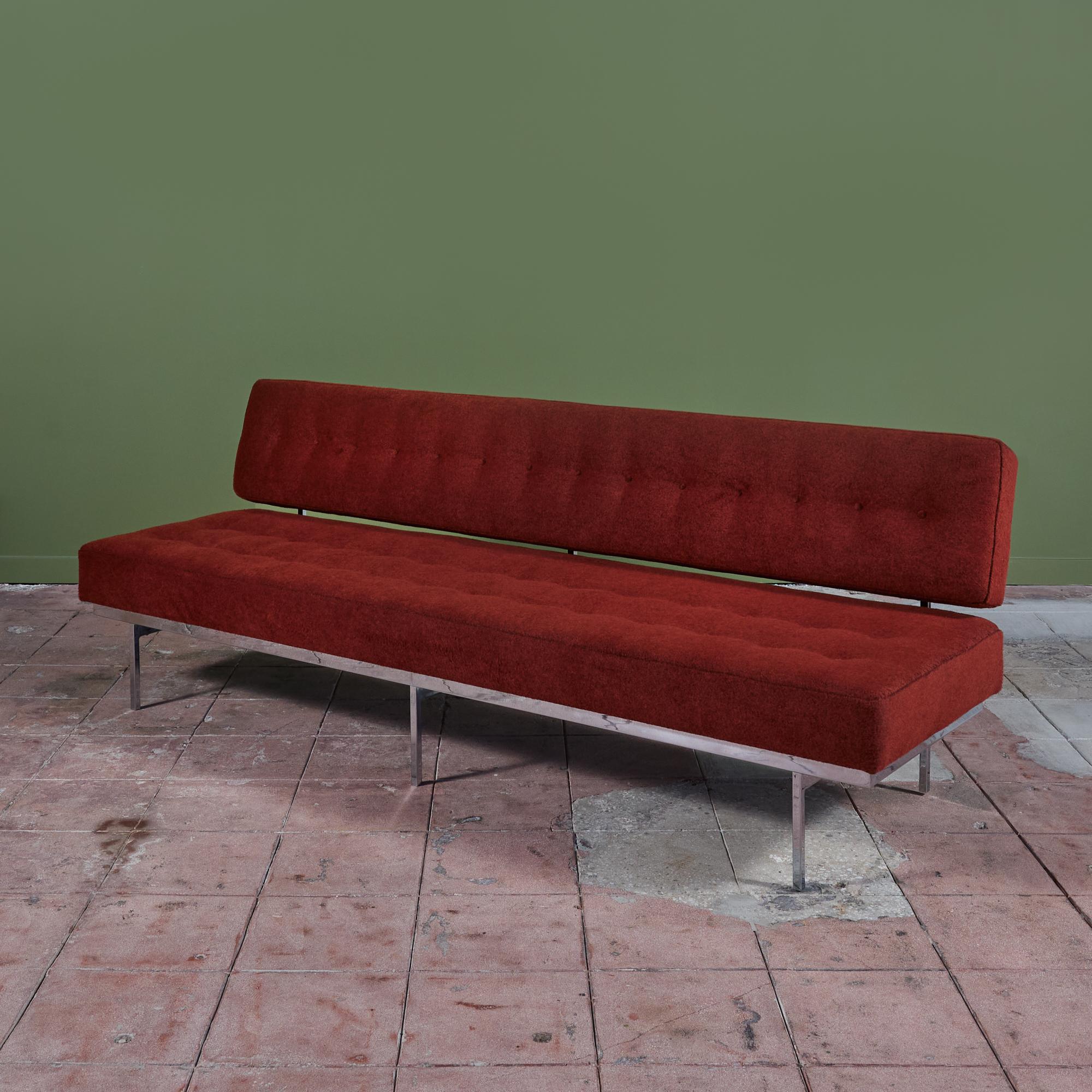 A classic mid-century tufted sofa by Florence Knoll Sofa for Knoll International c.1950s, USA. It can easily be floated in the center of a room as the backing is just as stunning as its front. It's long, horizontal design also appears to float above