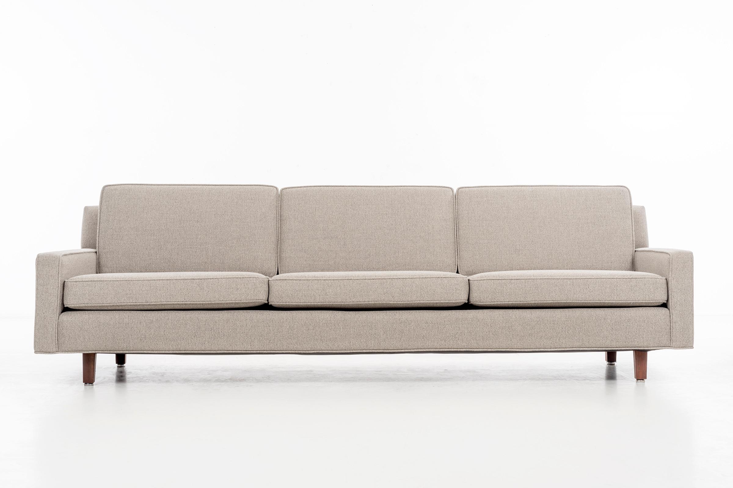 Florence Knoll three seat sofa model 96-1.
Solid oiled walnut legs recovered with great plains woven wool fabric.
 