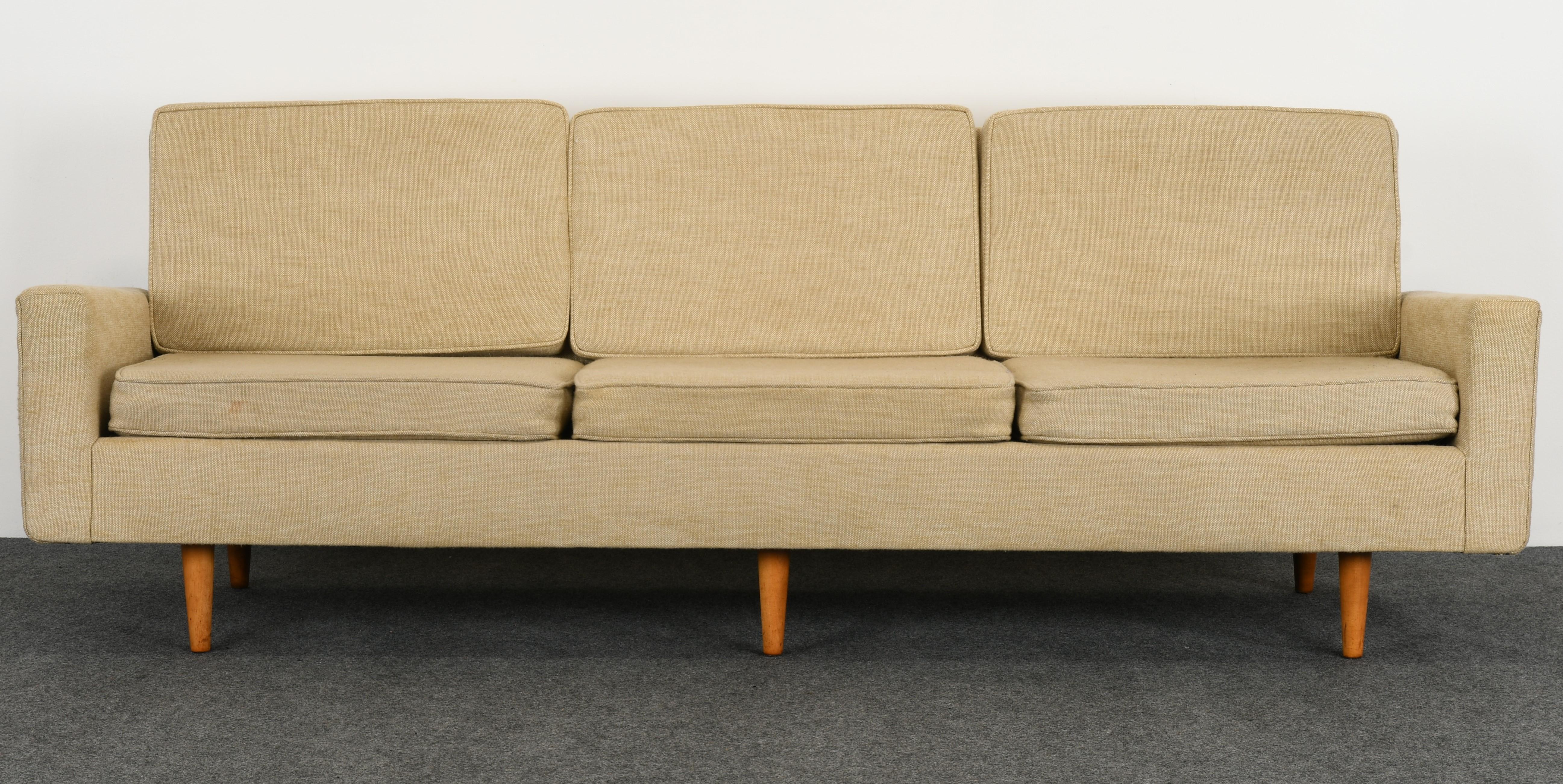 A Classic three-seat Knoll Sofa Model #26 designed by Florence Knoll was produced circa 1947-1970. Upholstered in natural linen, however, new upholstery is necessary. Great modern and classic form. This sofa is sturdy and structurally sound.
