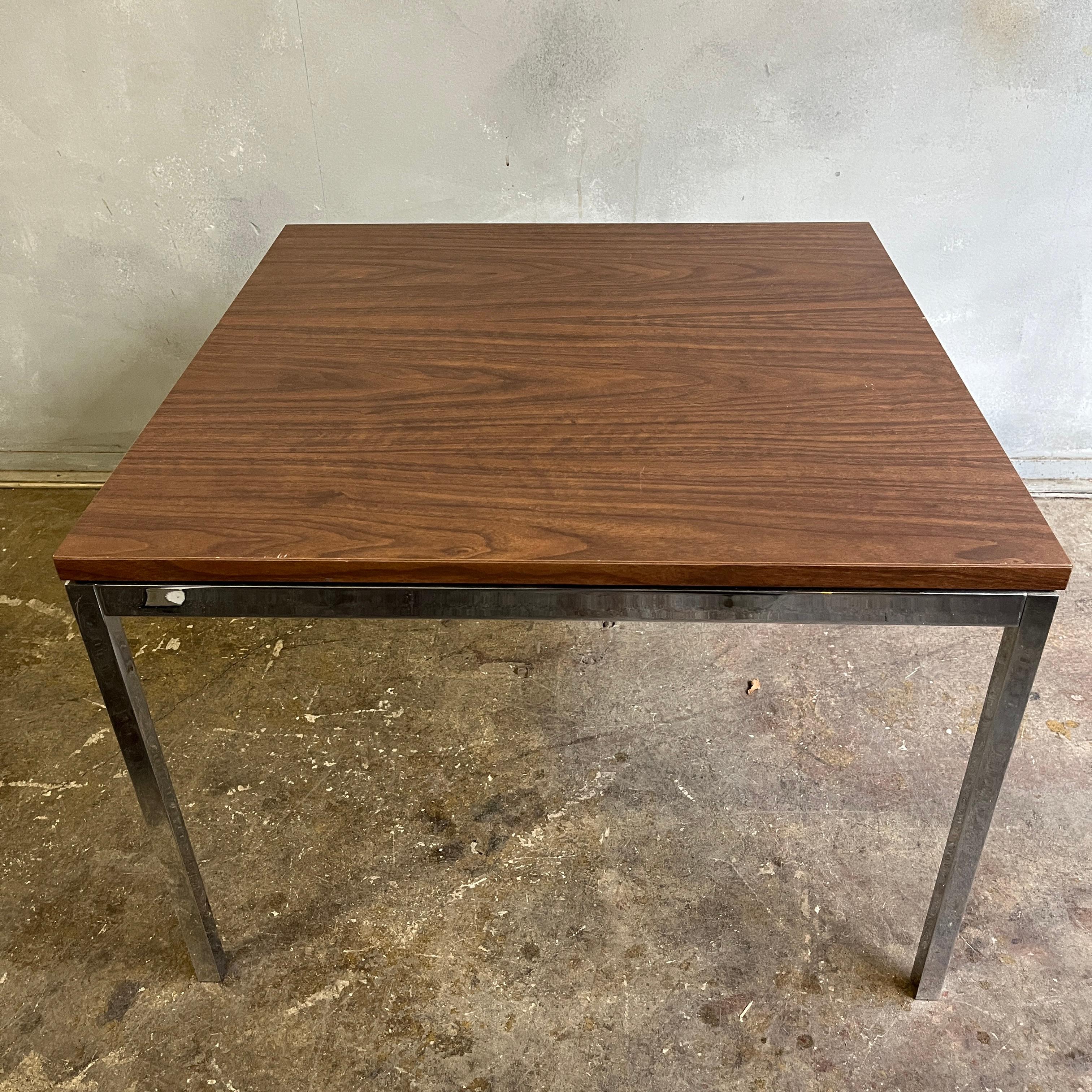 Original solid steel 24 inch square side tables by Florence Knoll with floating laminate walnut tops. We have multiple tables that can be used tide by side as a longer coffee table. Tops are also removable to fit marble tops.