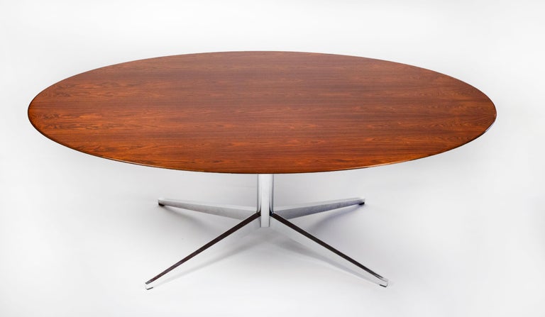 Early table/desk with a beautiful Brazilian rosewood top designed by Florence Knoll for Knoll International, 1961. This table is in excellent condition and was in the Joslyn Art Museums' private collection in Omaha Nebraska for many years. The