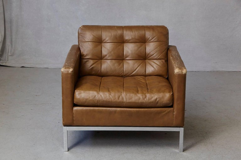 Florence Knoll lounge chair in tan leather with button tufted seat and back on a chrome-plated steel base. Labeled Art Metal - Knoll Corp., June 9 1971
The chair has some losses to the leather, which gives him some lovely patina. There is one