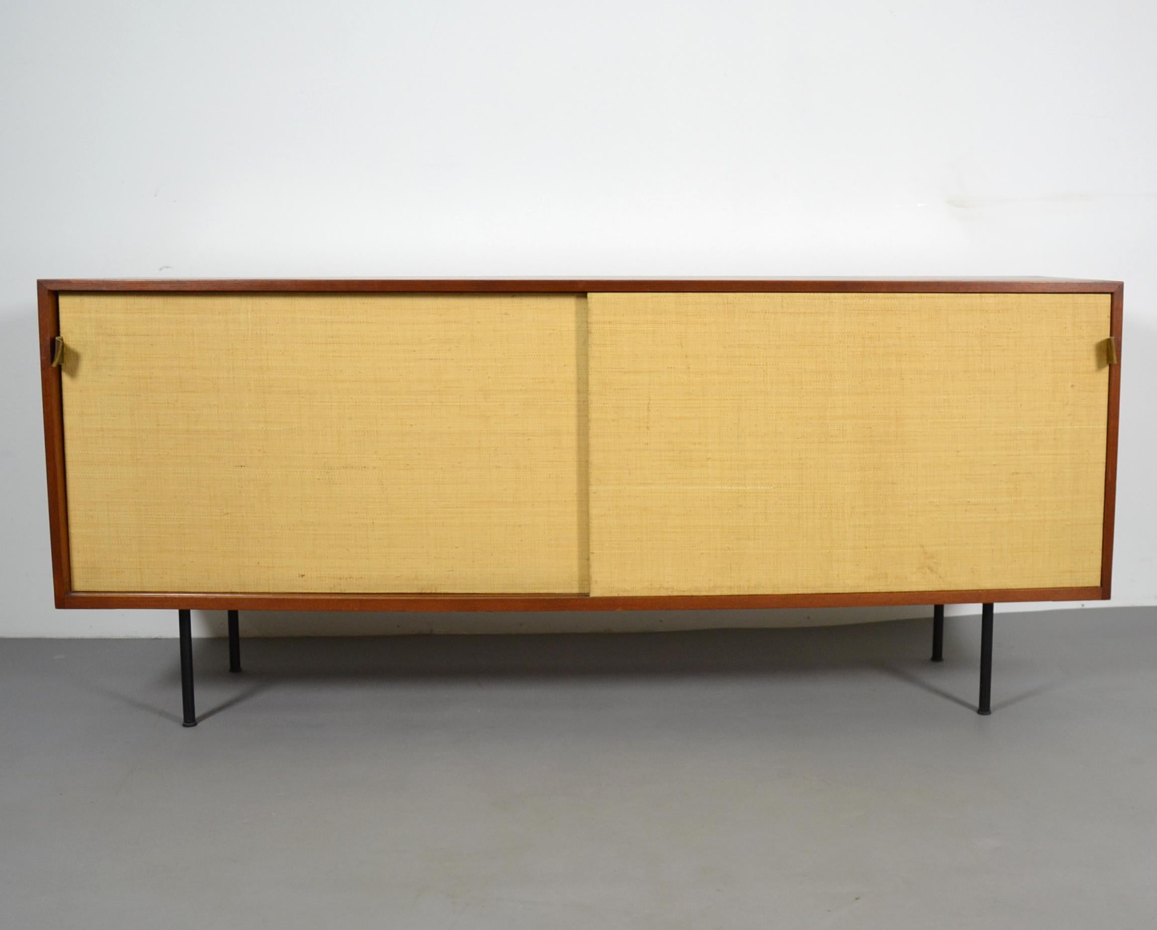 Design: Florence Knoll 1947
Manufacturer: Knoll International
Model: 116
Condition: used
Version with black metal legs, veneer in teak with bast sliding doors.
Florence Knoll Bassett was an American architect and designer.
She studied under