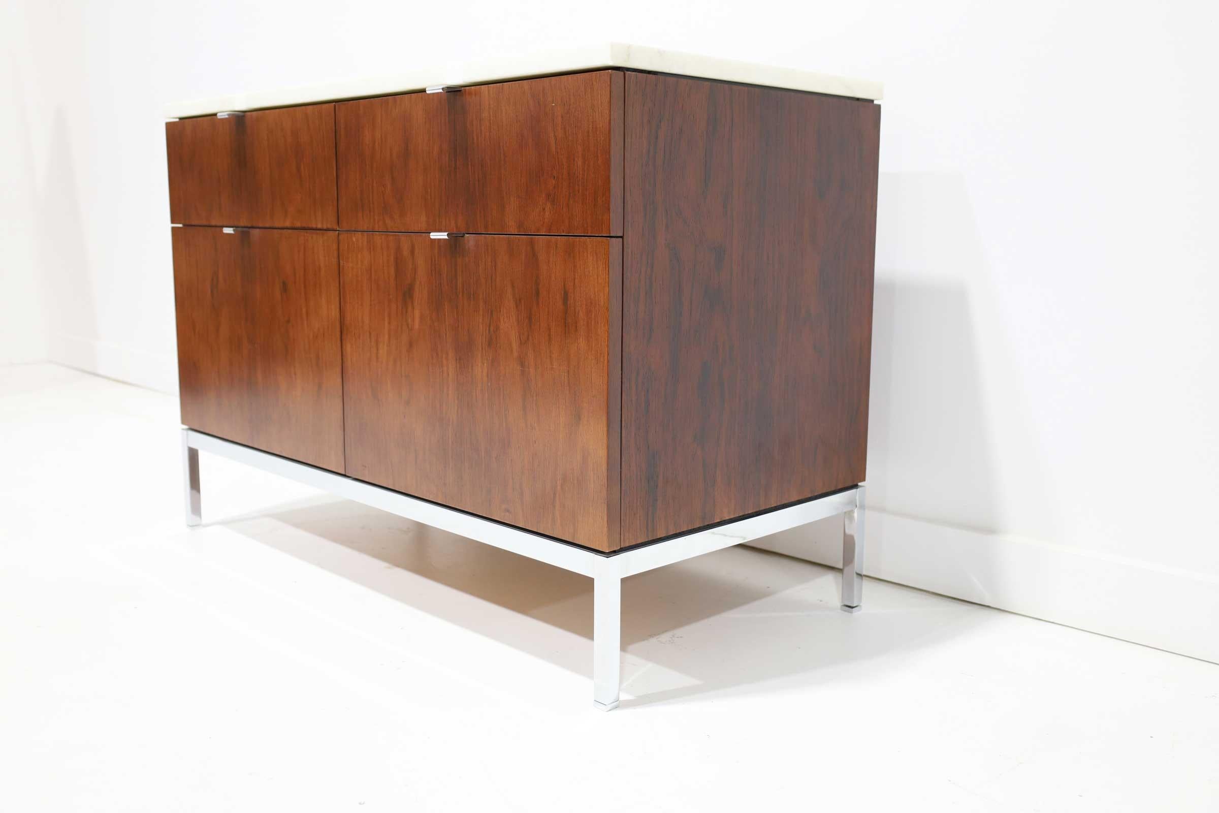 This is an early version Florence Knoll credenza, 1960s from an important collector. Small keyhole to slide key in and lock. We do not have the key. Marble is beautiful. Graining is beautiful. Oak interior. Pencil tray in one upper drawer. Finished