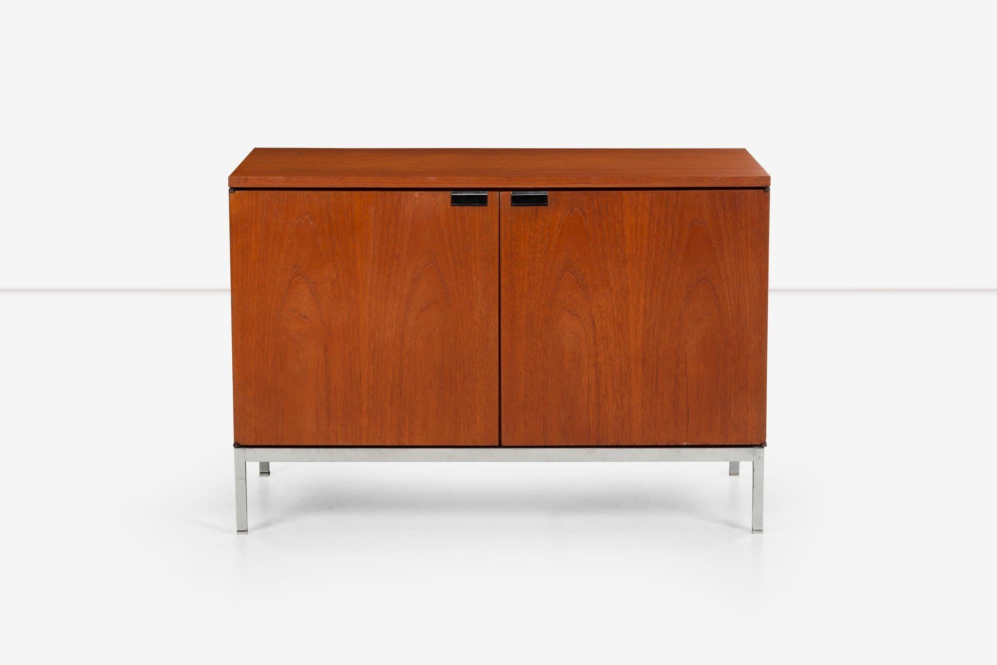 Florence Knoll two-door cabinet in Teakwood, Finished on back. Features Notch pulls with chrome details, Four file drawers and Four pencil drawers, and chrome-plated adjustable feet.
[Knoll label on underside 1976 stamp].