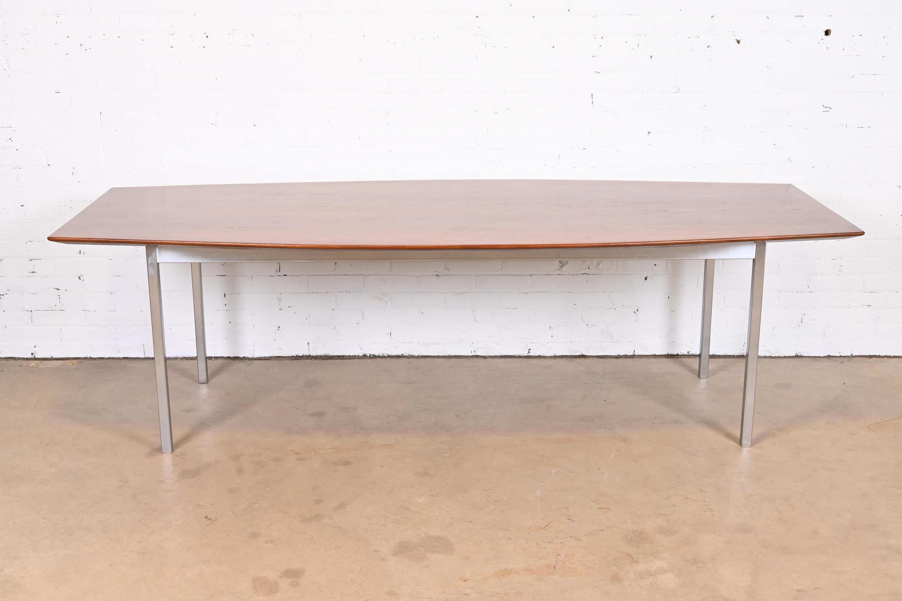 A sleek and stylish Mid-Century Modern boat shaped dining table or conference table

By Florence Knoll for Knoll Associates

USA, Circa 1960s

Stunning book-matched walnut top, with polished chrome steel apron and legs.

Measures: 96
