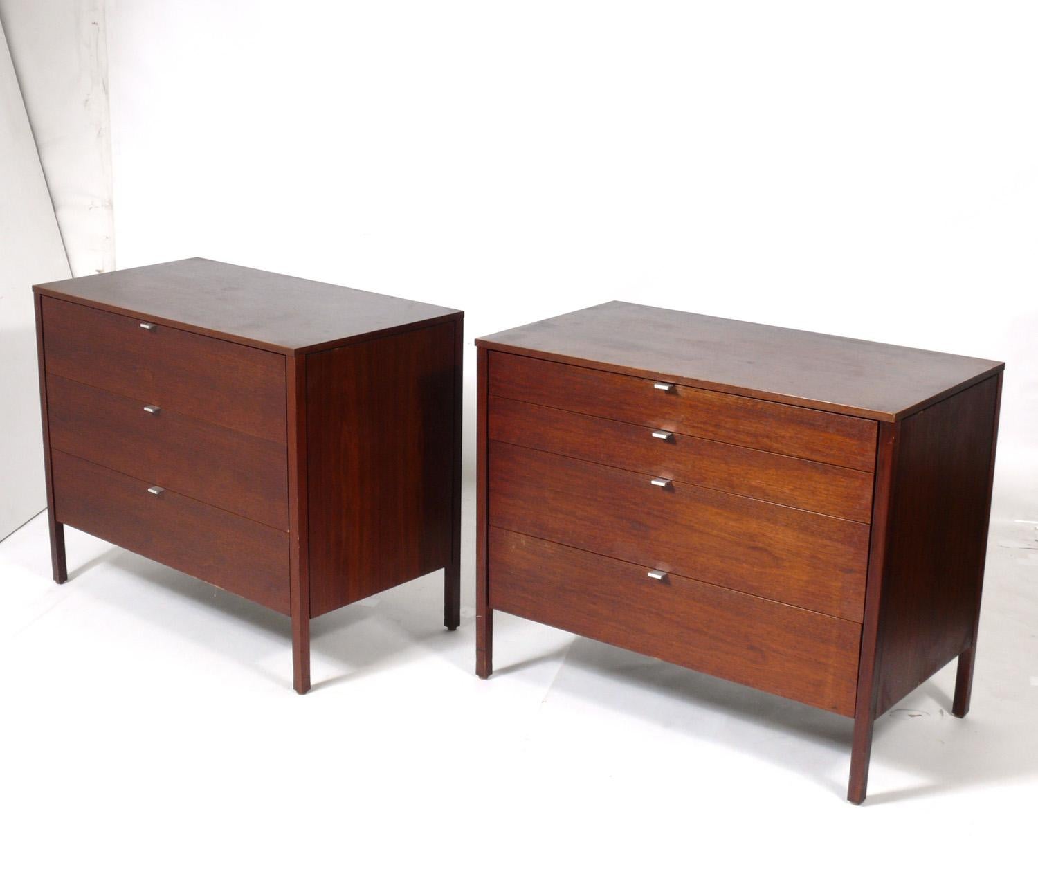 Clean lined mid century walnut chests, designed by Florence Knoll for Knoll, circa 1950s. They offer a voluminous amount of storage with four deep drawers in each chest. They are priced at $3500 each or $6000 for the pair.